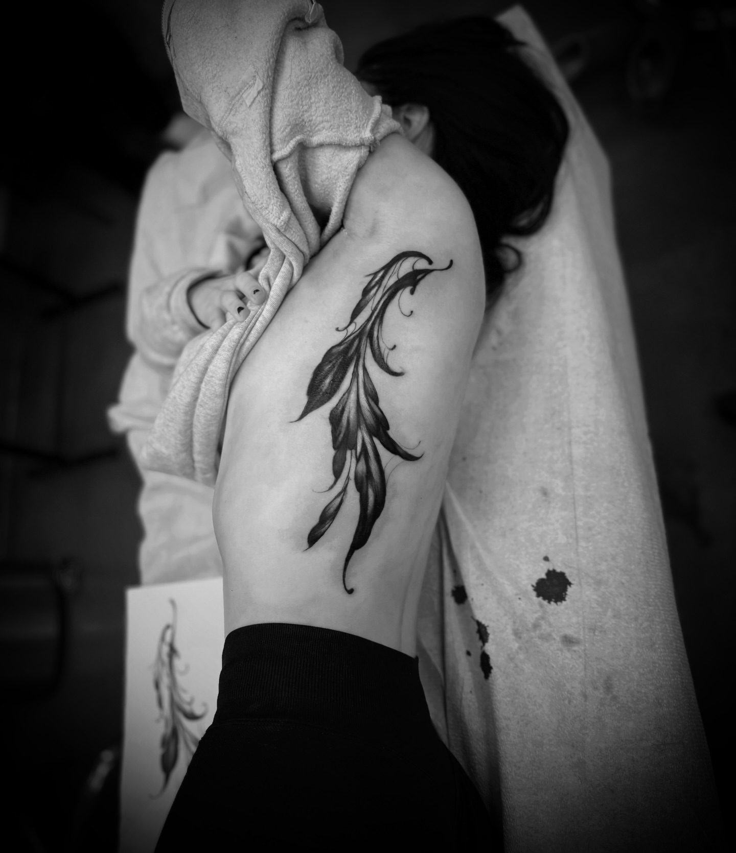 Feather black and grey tattoo on the shoulder by Julian Olson