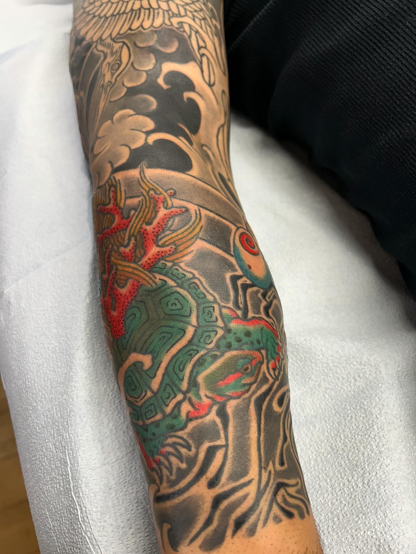 Dragon and waves japanese irezumi tattoo on the forearm by Matthew Crimson