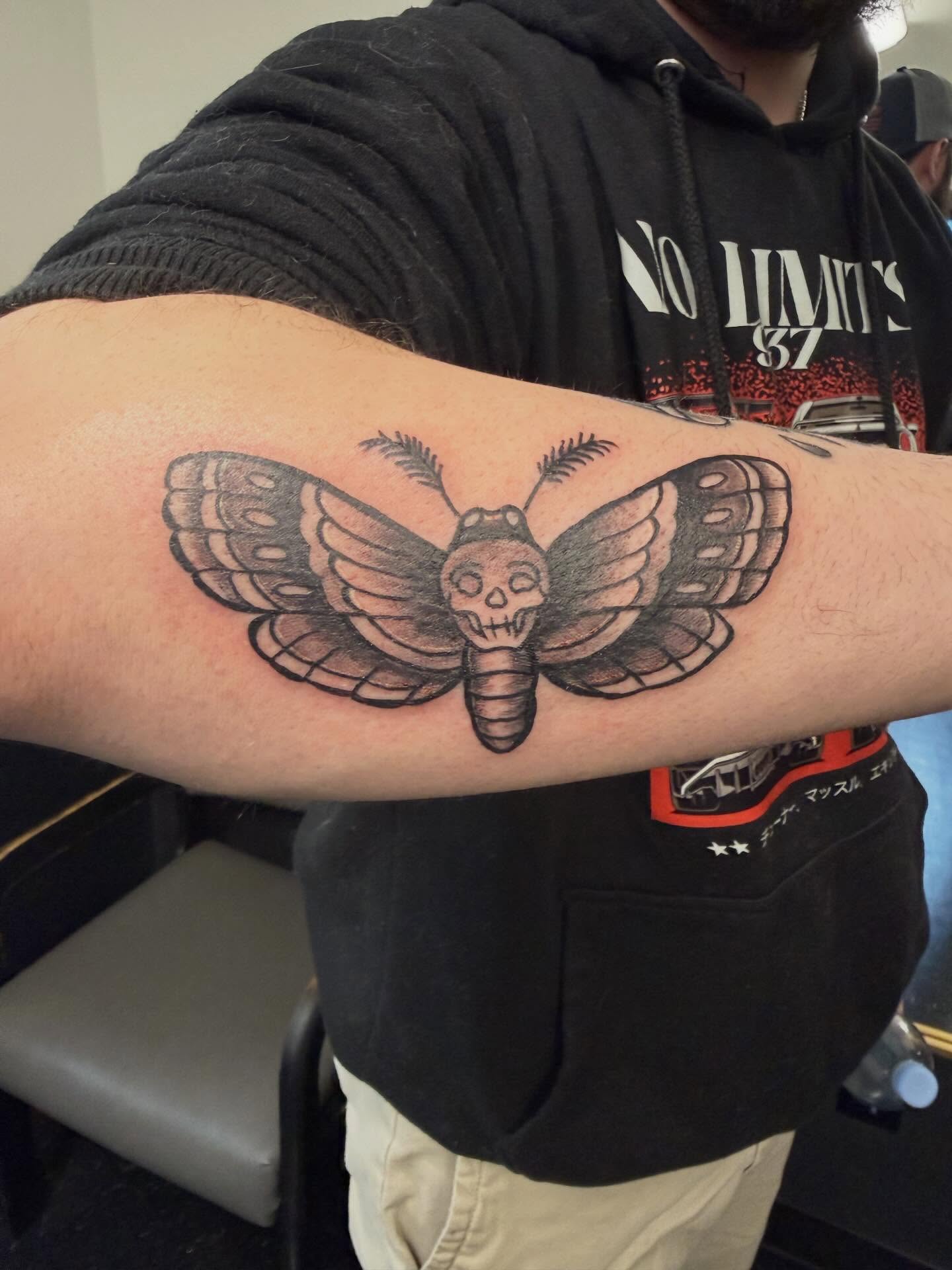 Moth skull American traditional tattoo on the forearm by Daniel Smith