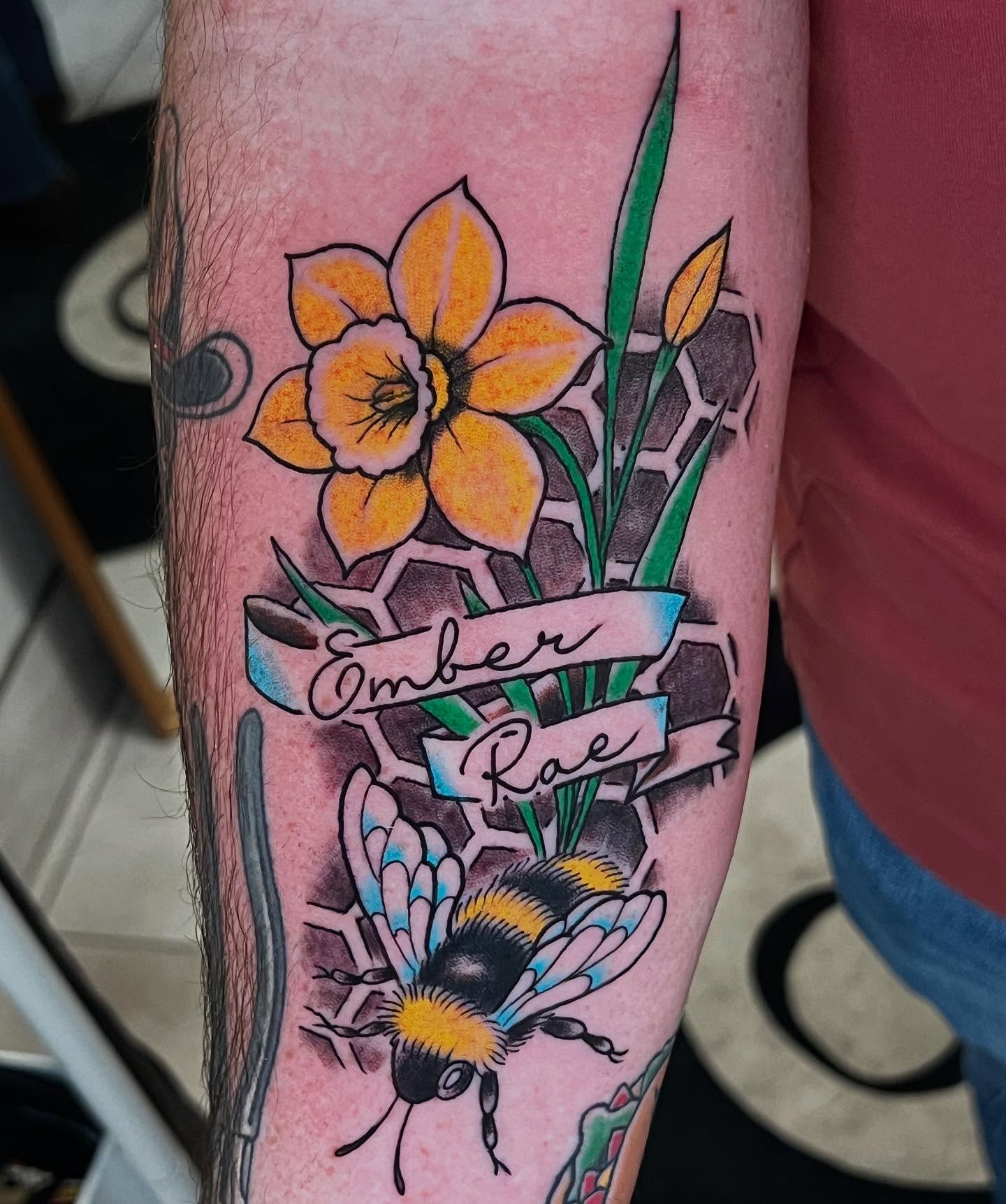 Daffodil and bee American traditional tattoo on the forearm by Levi Cox, Powell, Ohio