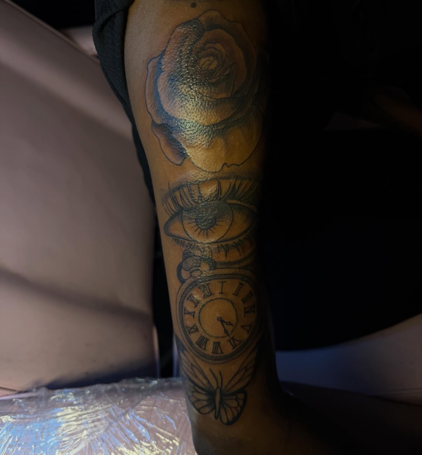 Rose, eye, pocket watch, butterfly realism tattoo on the forearm by Tatted By Layy