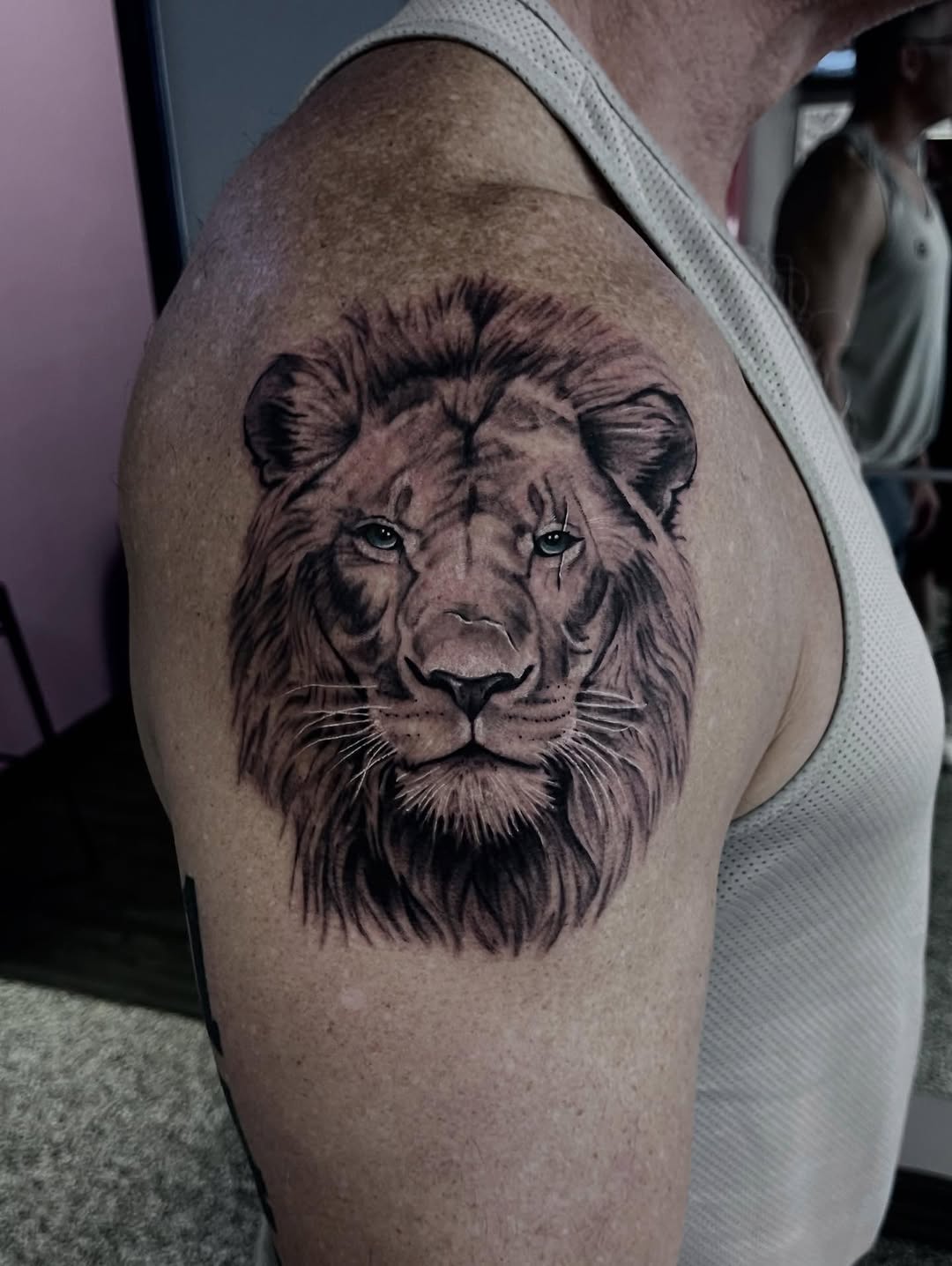 Lion portrait realism tattoo on the shoulder by Jonathan Red
