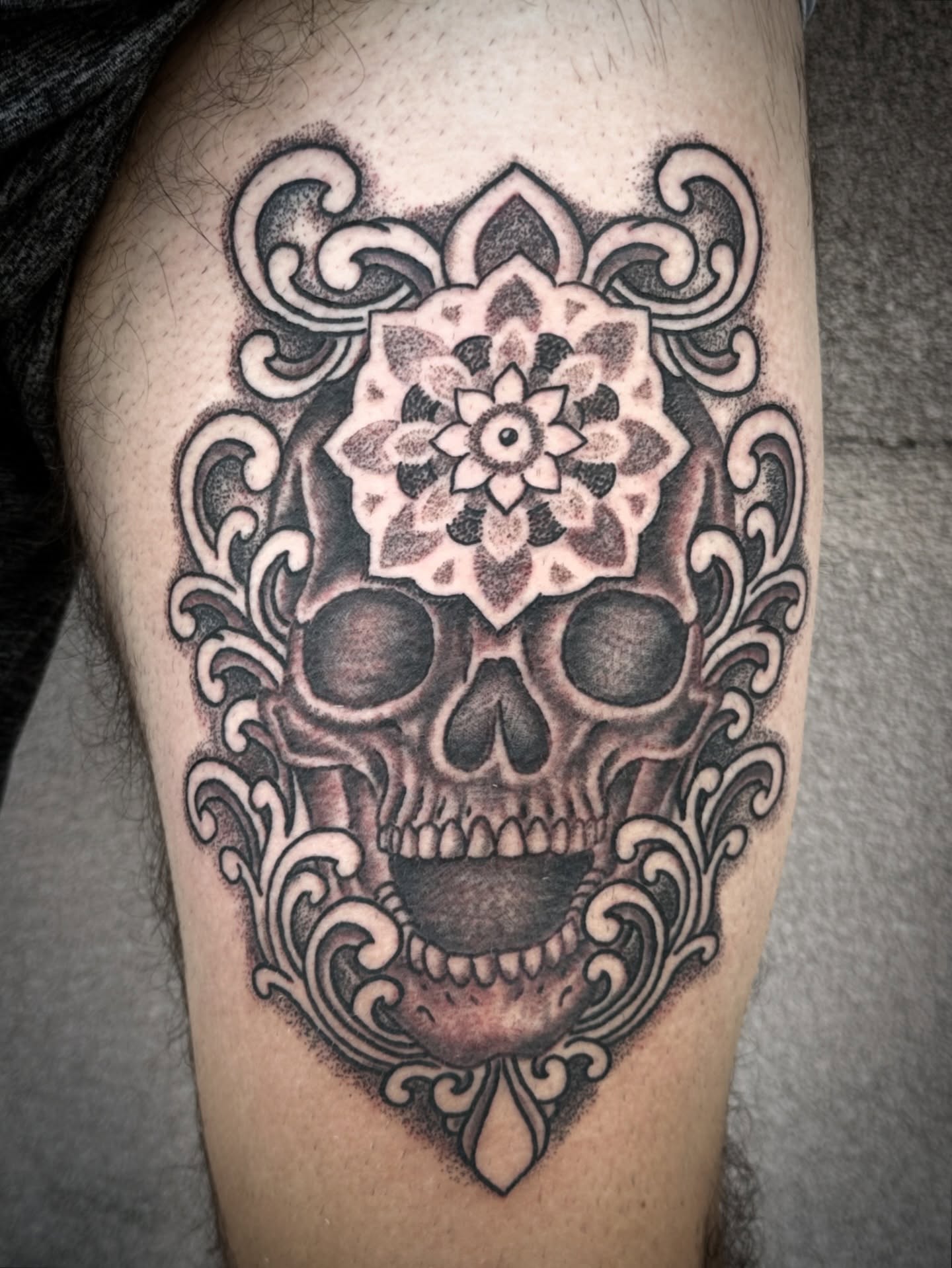 Skull with floral mandala ornamental tattoo on the thigh by Chris Blanchard