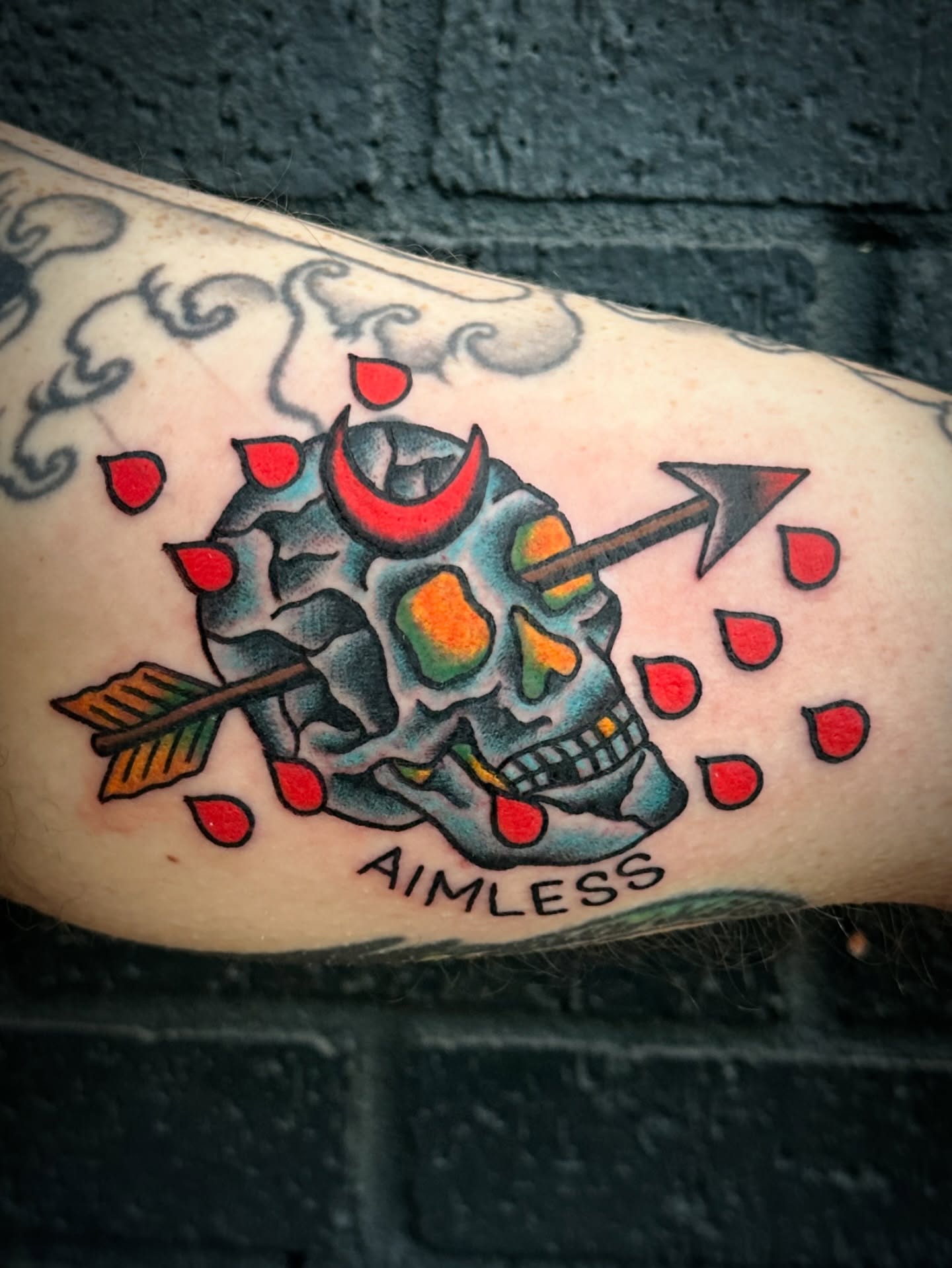 Skull with arrow American traditional tattoo on the forearm by Chris Blanchard