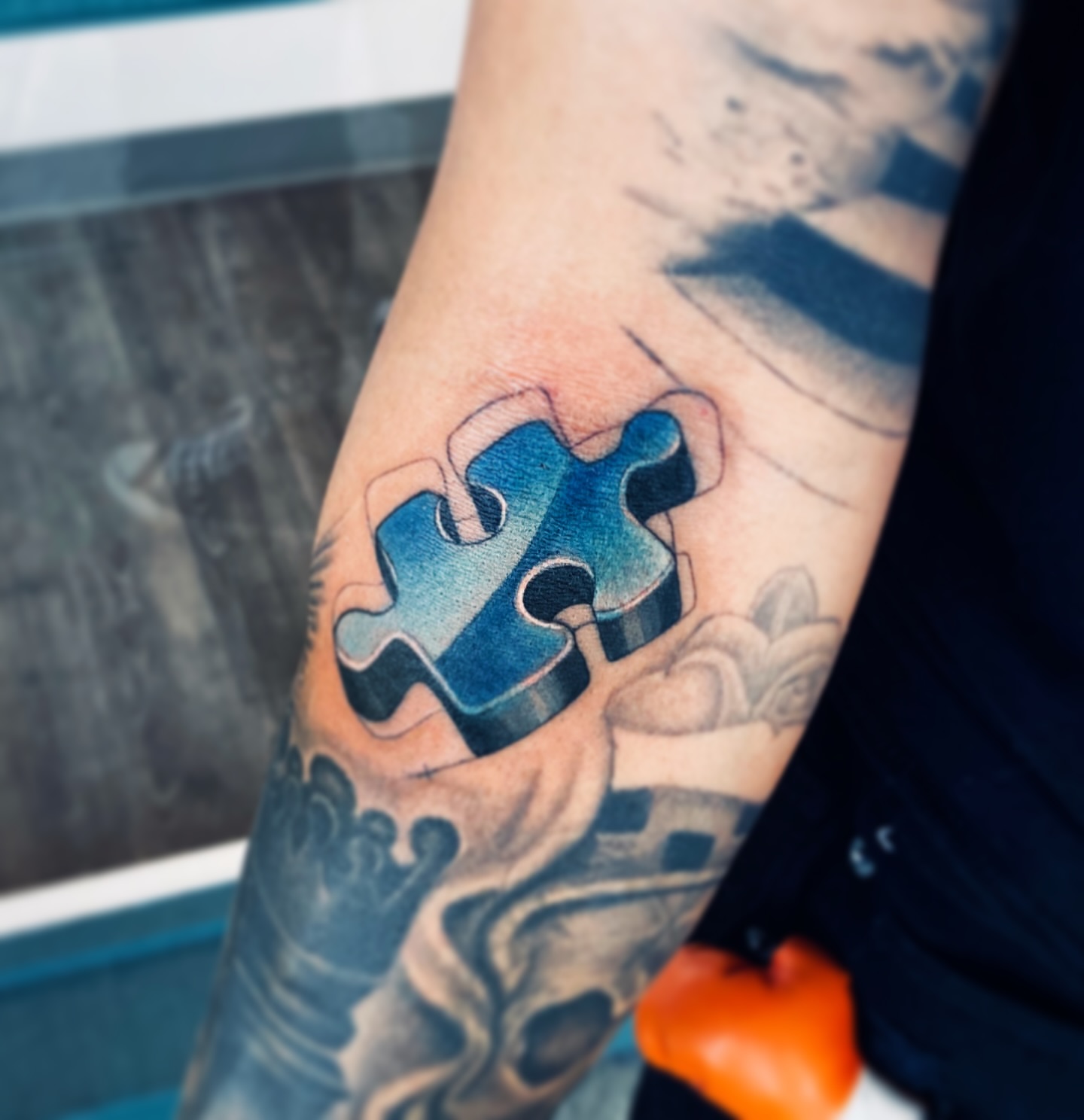 Jigsaw puzzle piece realism tattoo on the forearm by Ivana Belakova
