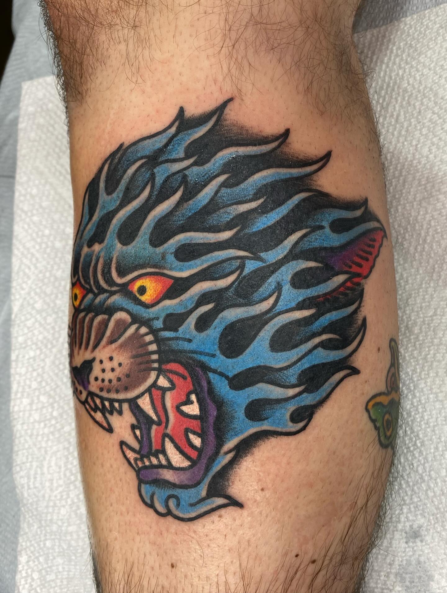 Flaming panther American traditional tattoo on the forearm by Jack, Knoxville, Tennessee