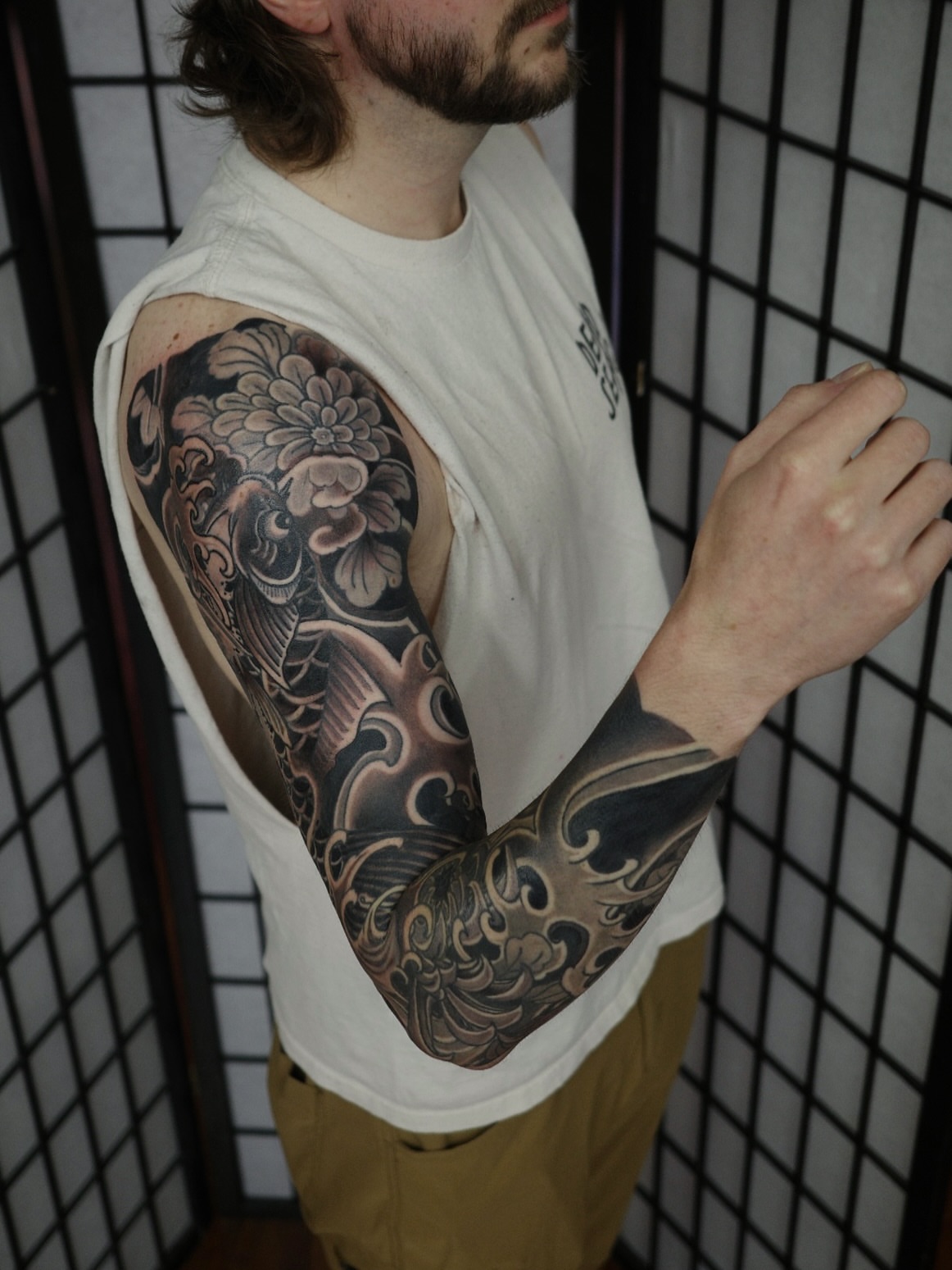 Koi fish and floral japanese irezumi tattoo on the upper arm by Innokenty Meshchakov, Portland, Oregon