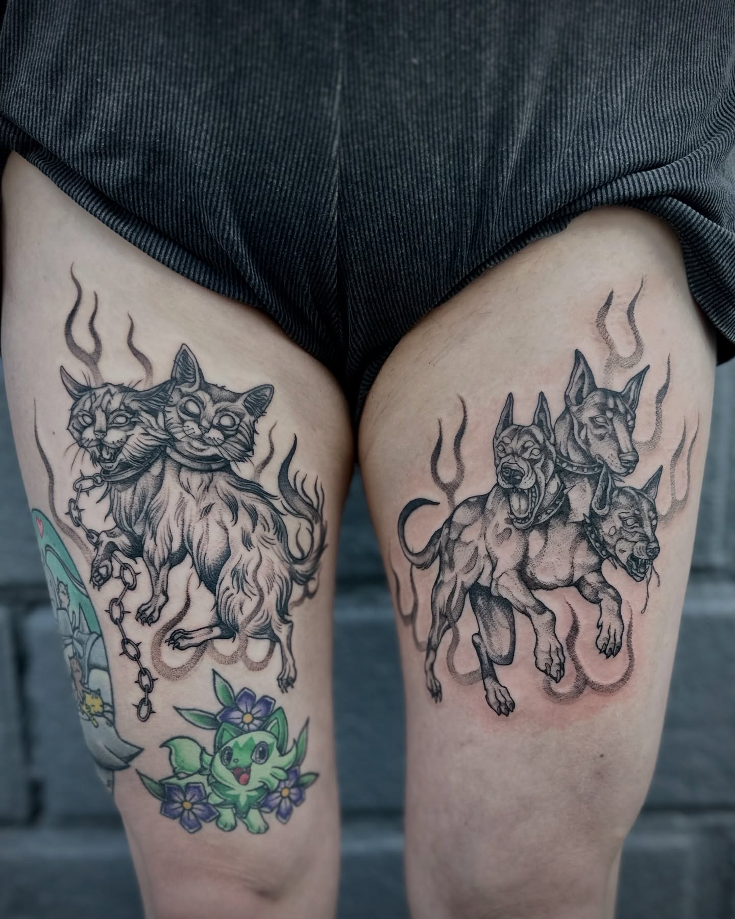 Three-headed cat and three-headed dog black and grey tattoo on the thigh by โฃ ๐ฝ๐๐๐๐๐ ๐ฟ๐๐๐๐๐๐๐๐๐๐๐ โฃ