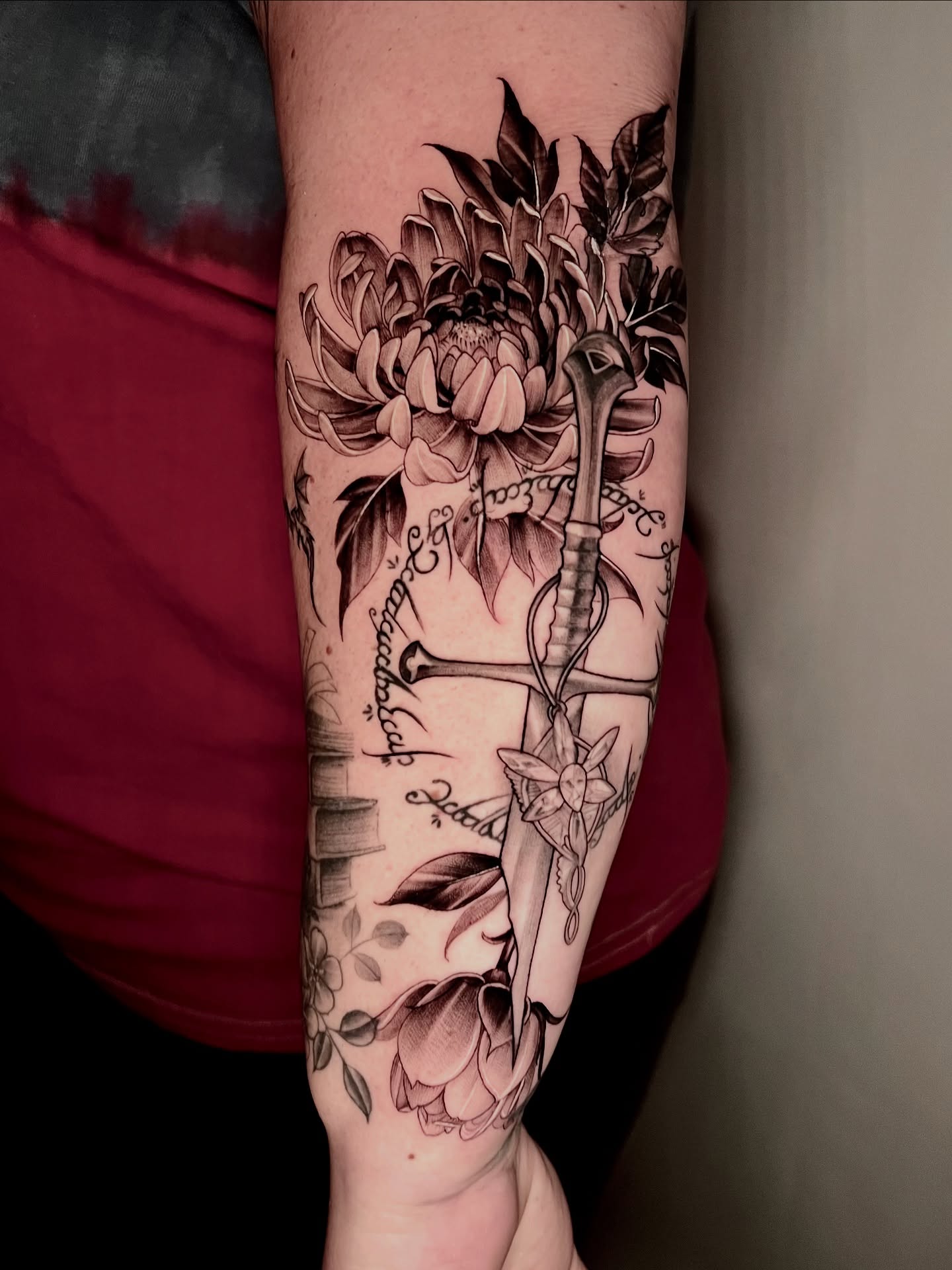 Flower and dagger realism tattoo on the forearm by Joi Bailey, Denton, Texas