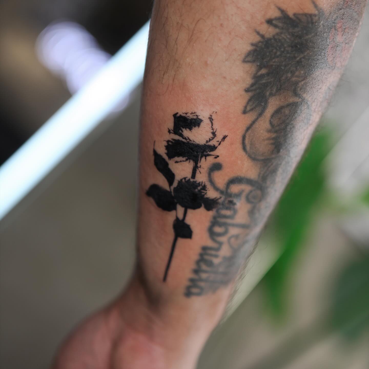 Rose silhouette black and grey tattoo on the forearm by Liv