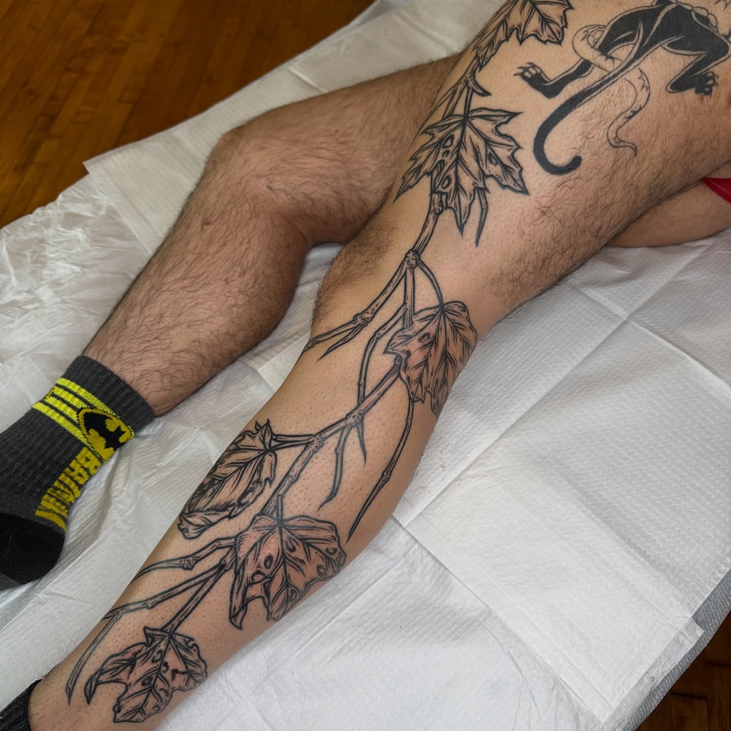 Vine and leaves black and grey tattoo on the forearm by rosalie