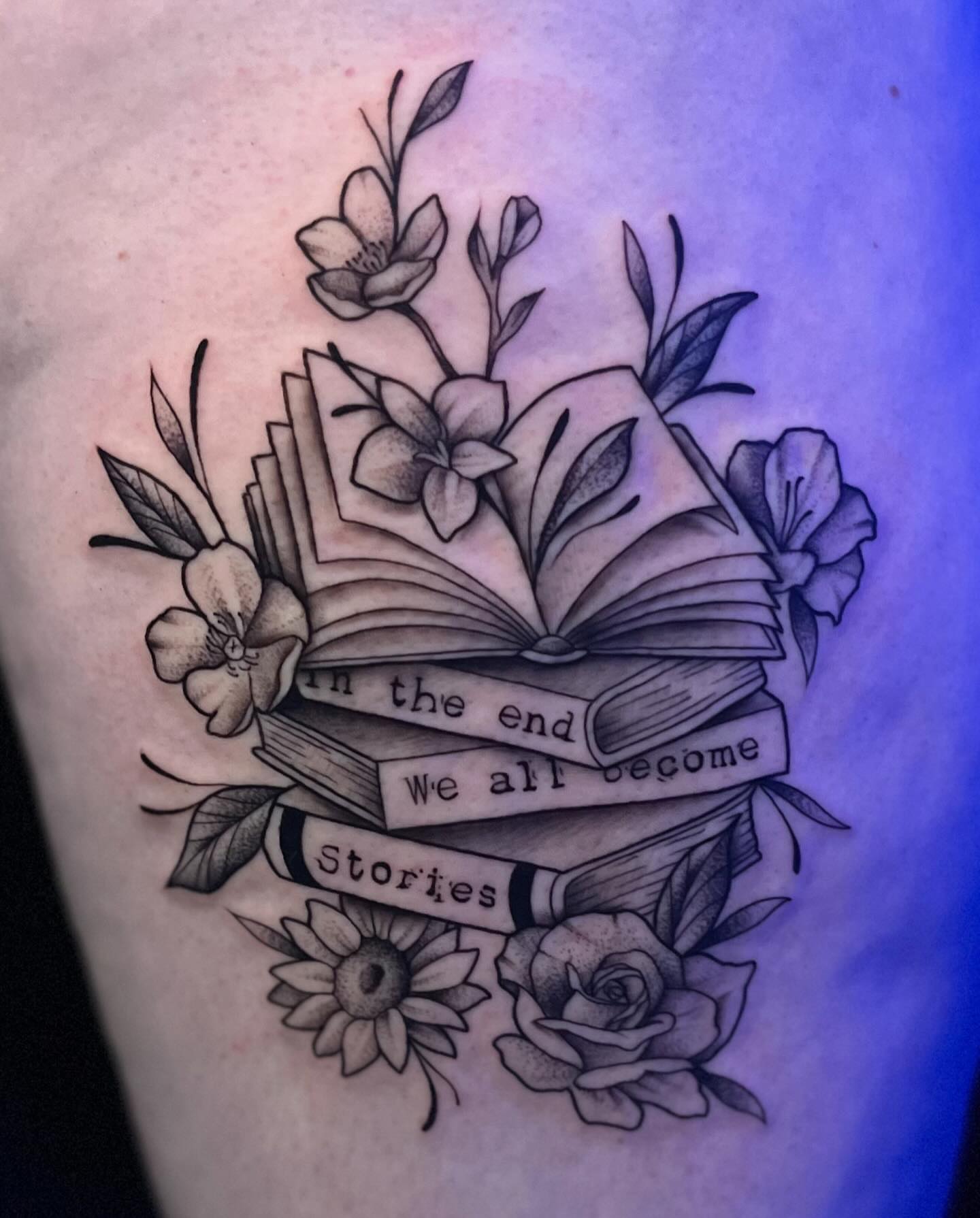 Book and flowers realism tattoo on the thigh by Lexi Ross