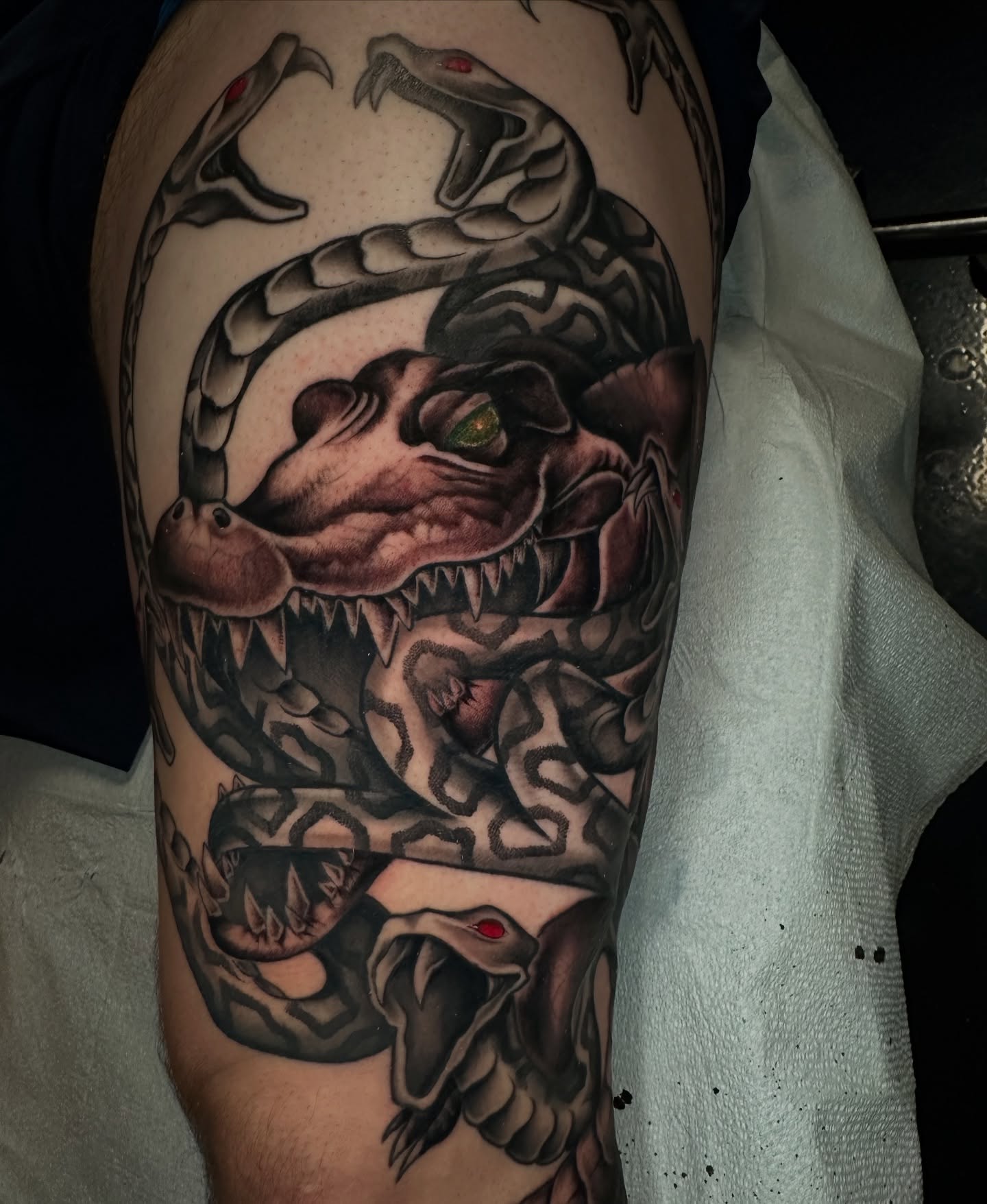 Serpent realism tattoo on the thigh by Sam Minneci