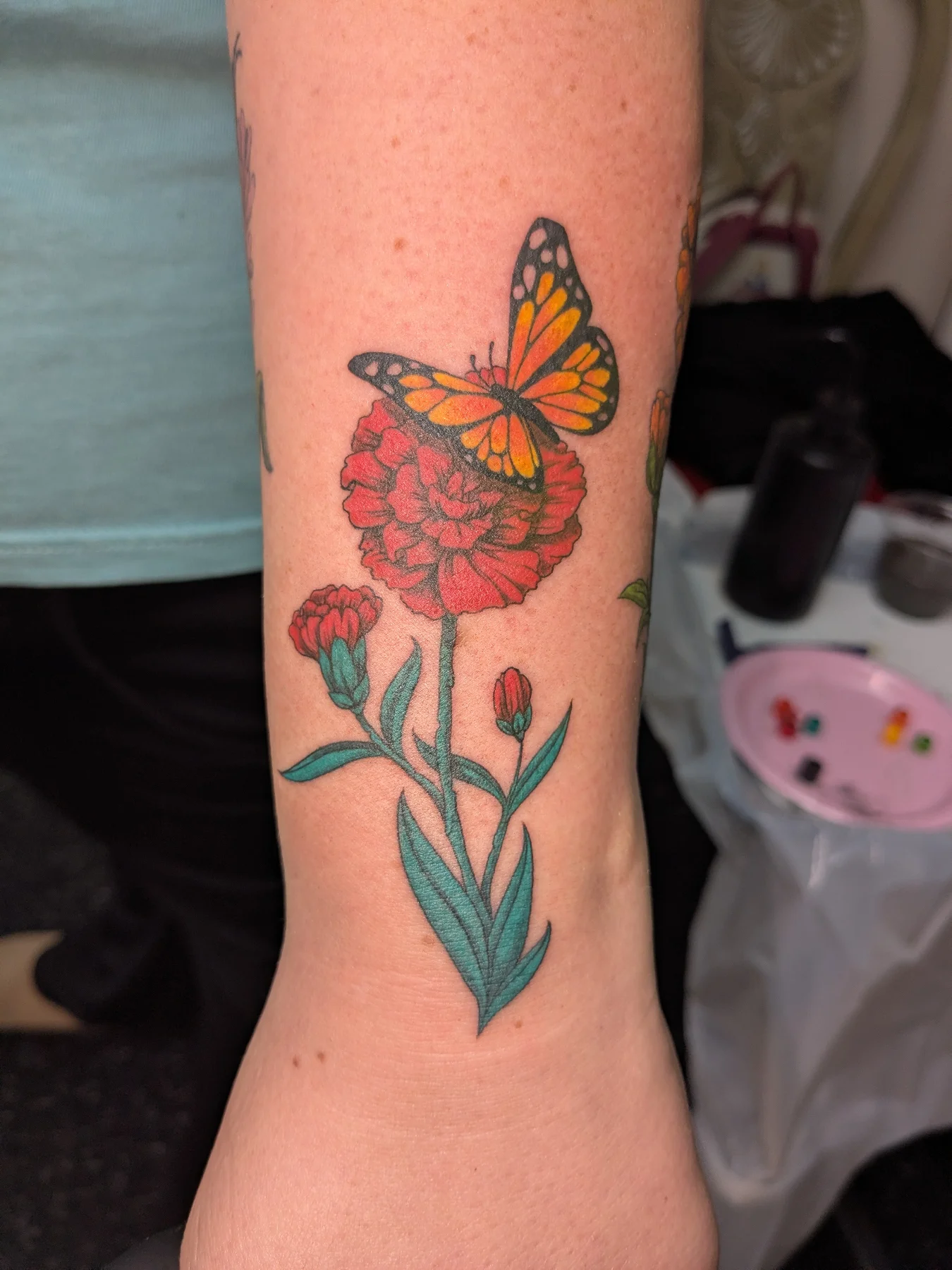 Butterfly and flower realism tattoo on the forearm by Jessica Thomas Fleischman, Morganton, North Carolina