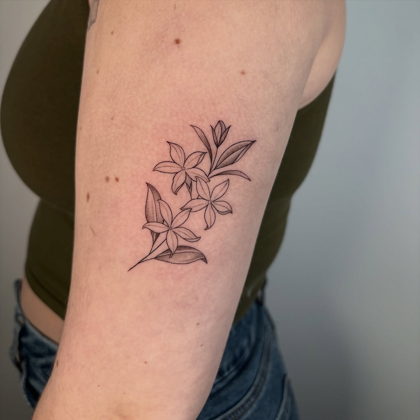 Flowers black and grey tattoo on the forearm by Fineline tattoos by Kinsey