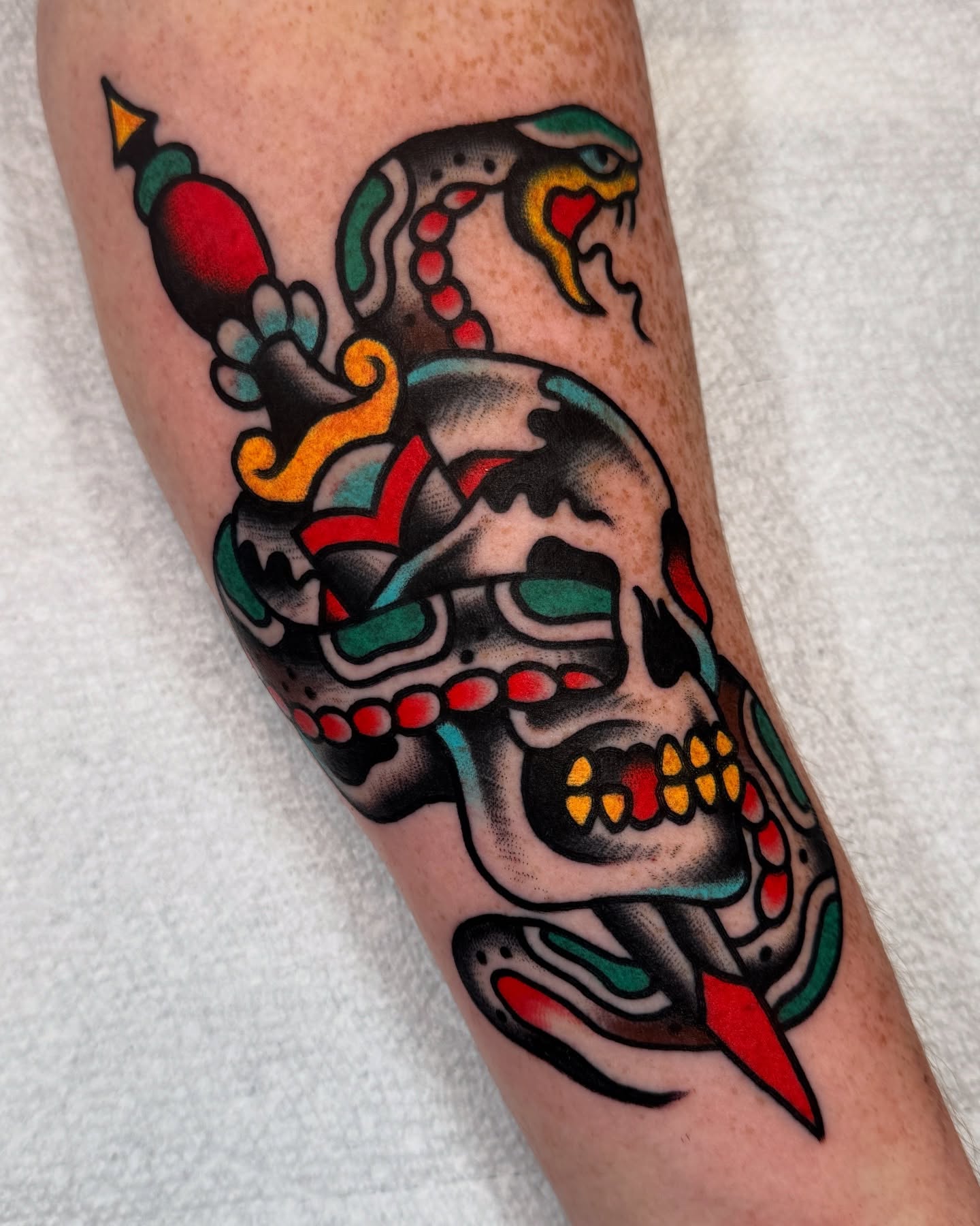 Skull with snake American traditional tattoo on the forearm by Cullen Bleser Quinn