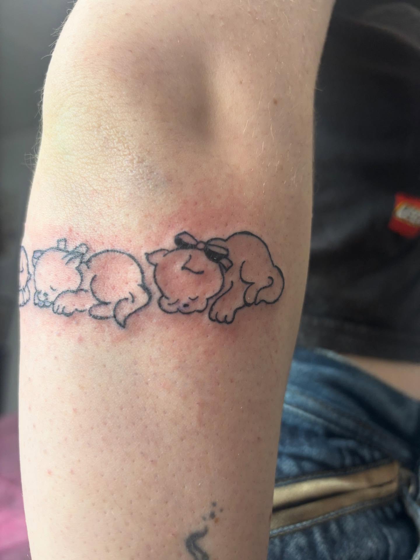 Sleeping puppies black and grey tattoo on the forearm by Mickey