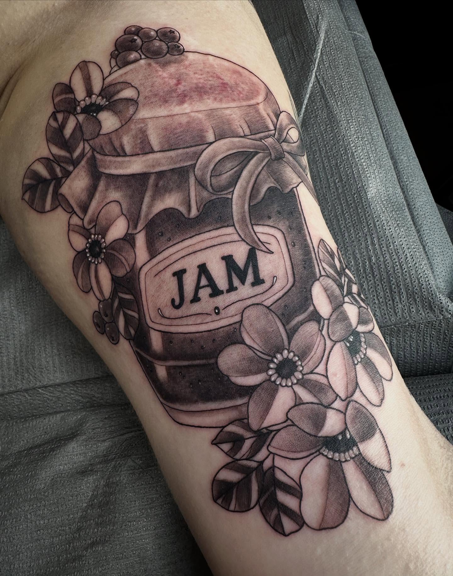 Jar of jam black and grey tattoo on the forearm by Son Salem