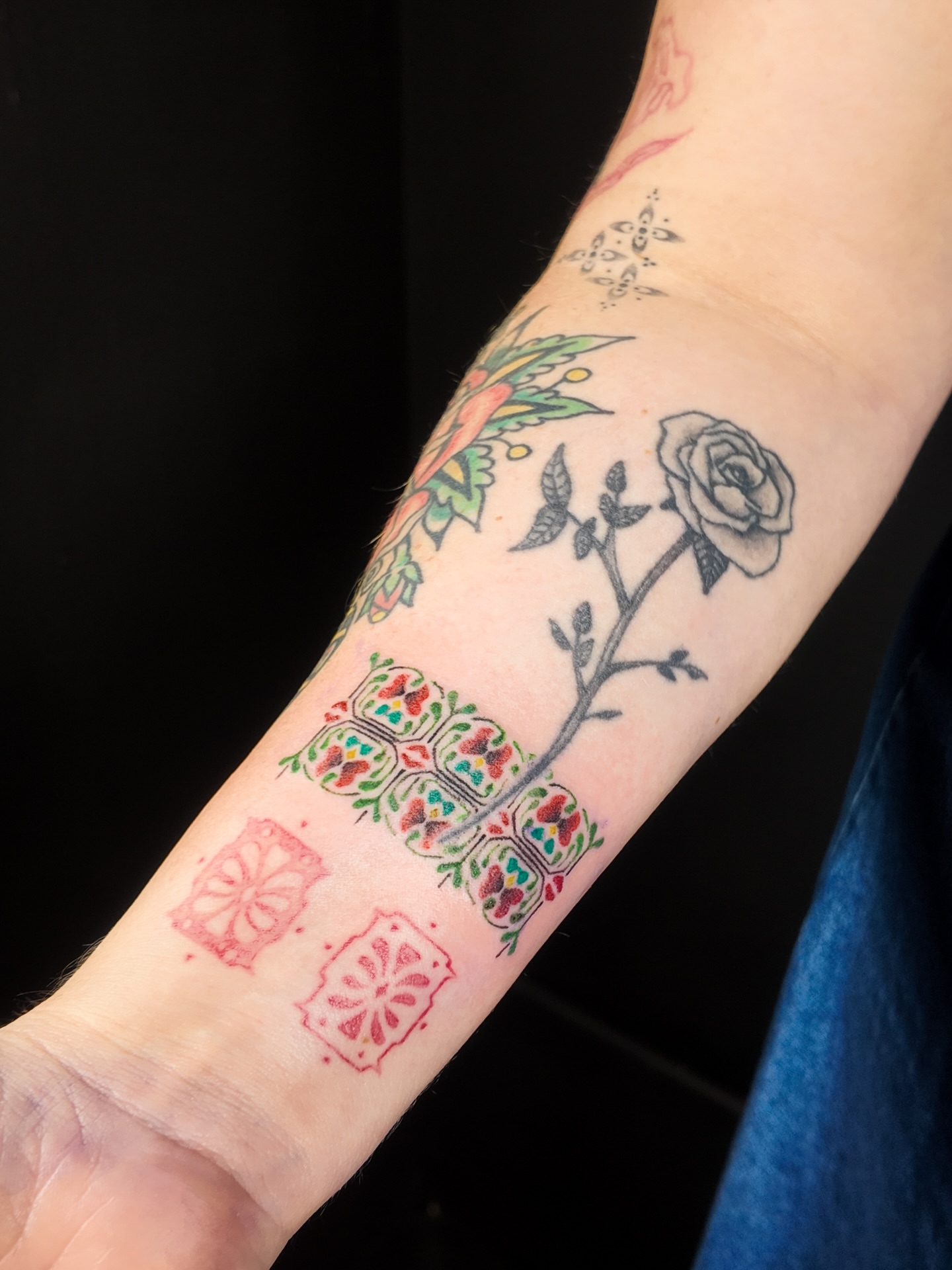 Rose and sugar skulls Chicano tattoo on the forearm by Micah Light (color micro realism, Los Angeles, California