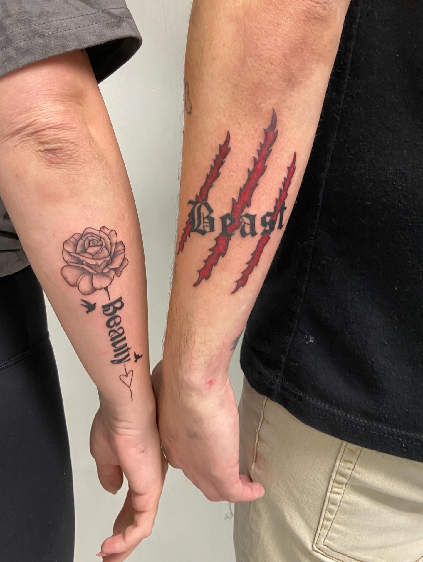 Beauty and beast black and grey tattoo on the forearm by Sophia