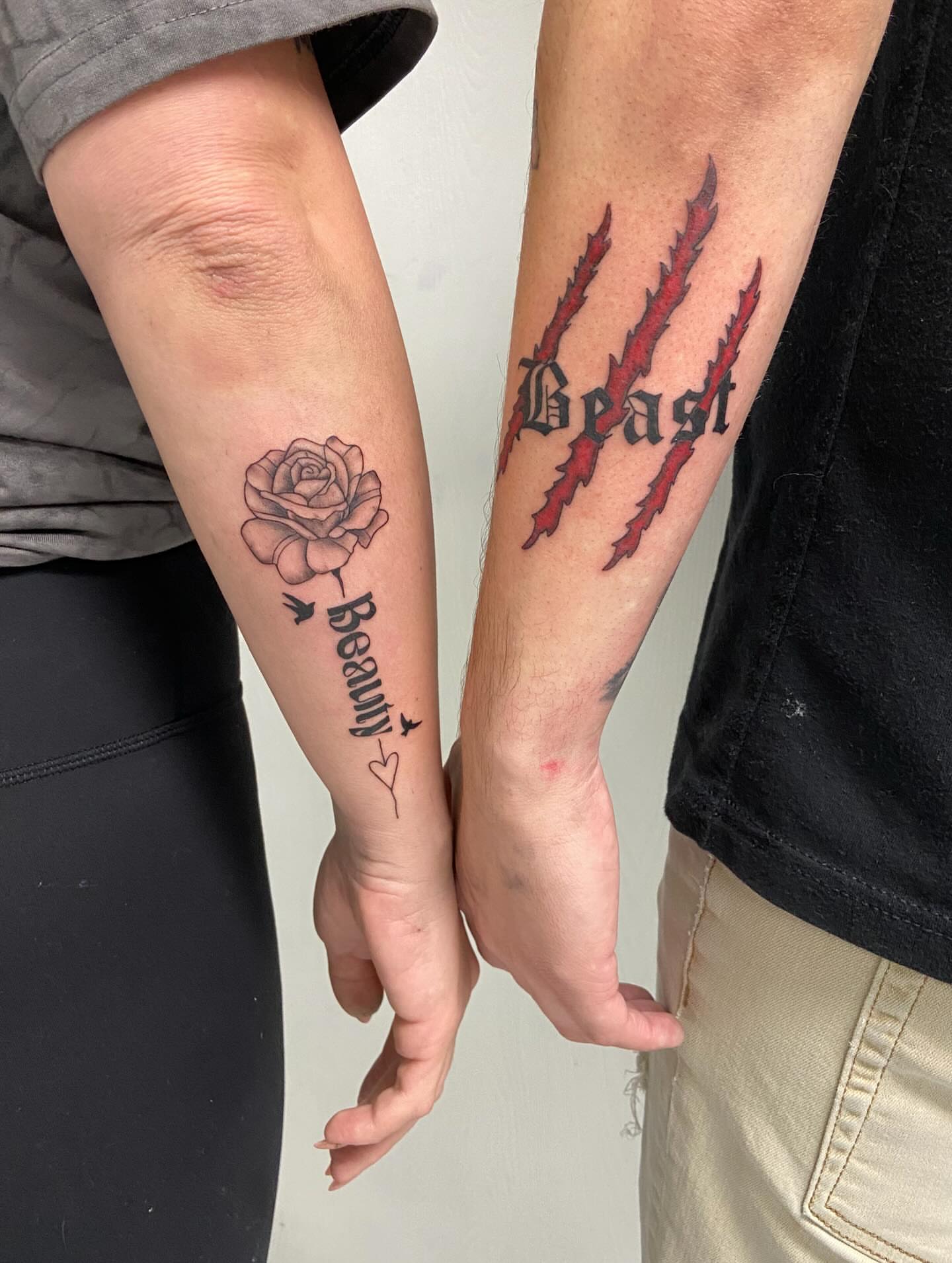 Beauty and beast realism tattoo on the forearm by Sophia