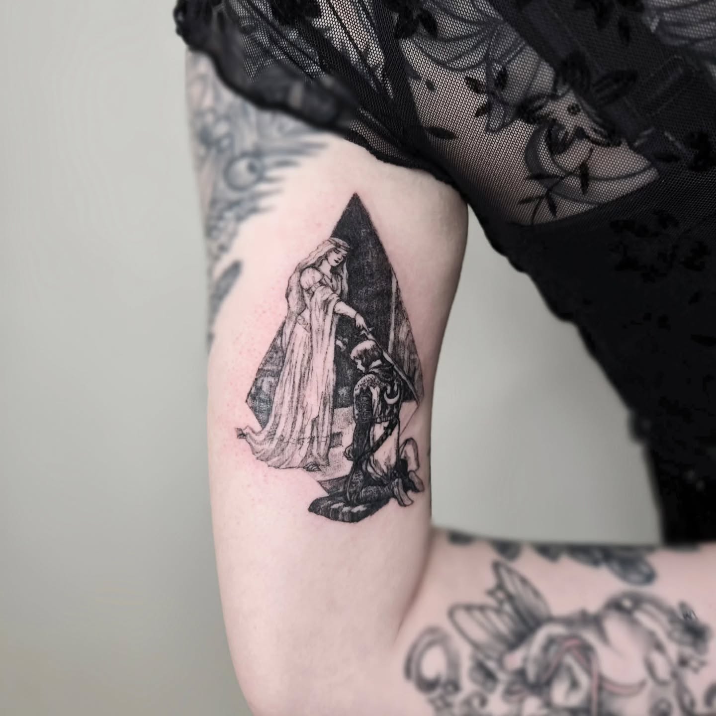Woman and kneeling figure realism tattoo on the forearm by Vintage tattoo