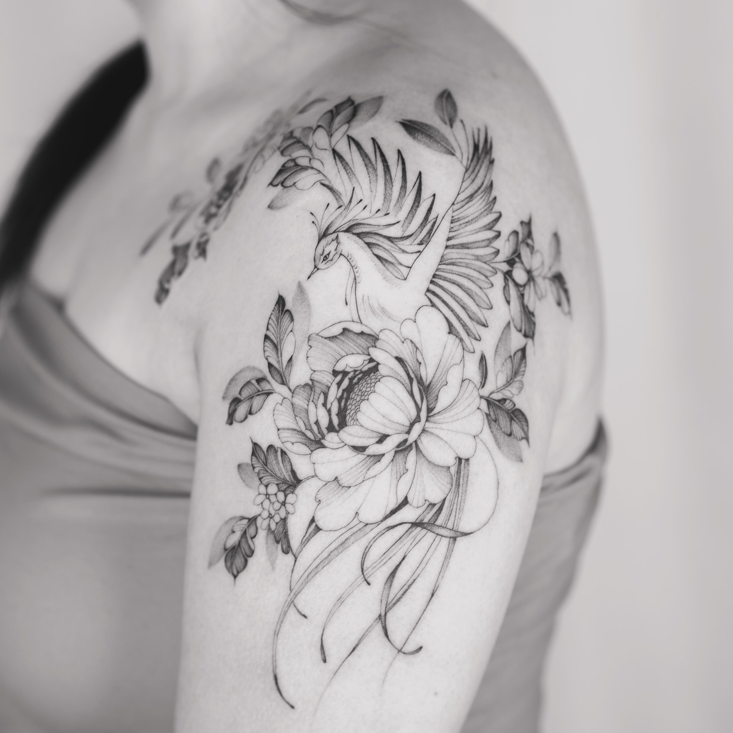 Peacock and floral bouquet realism tattoo on the shoulder by Leo Gao