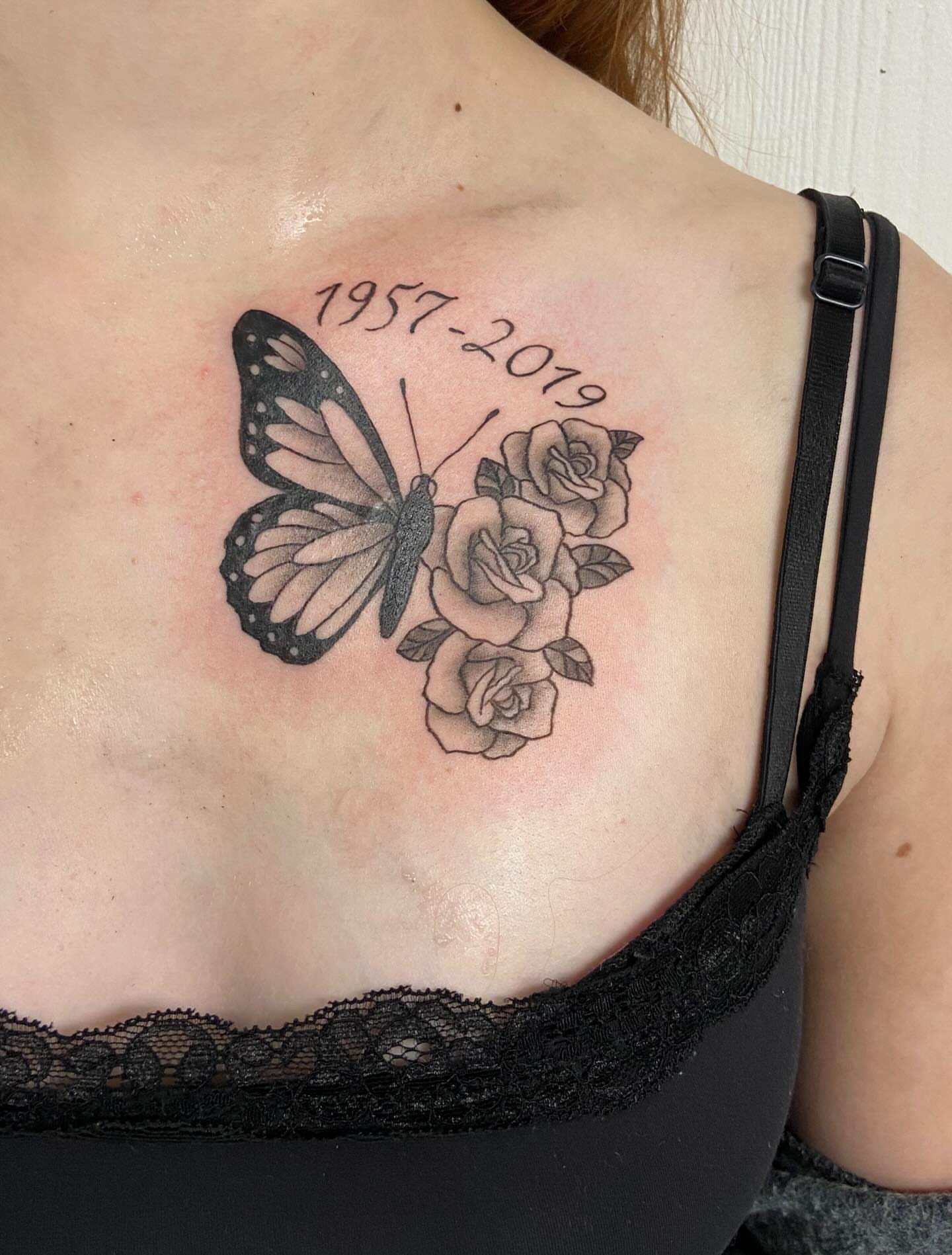 Butterfly and roses black and grey tattoo on the chest by Sophia