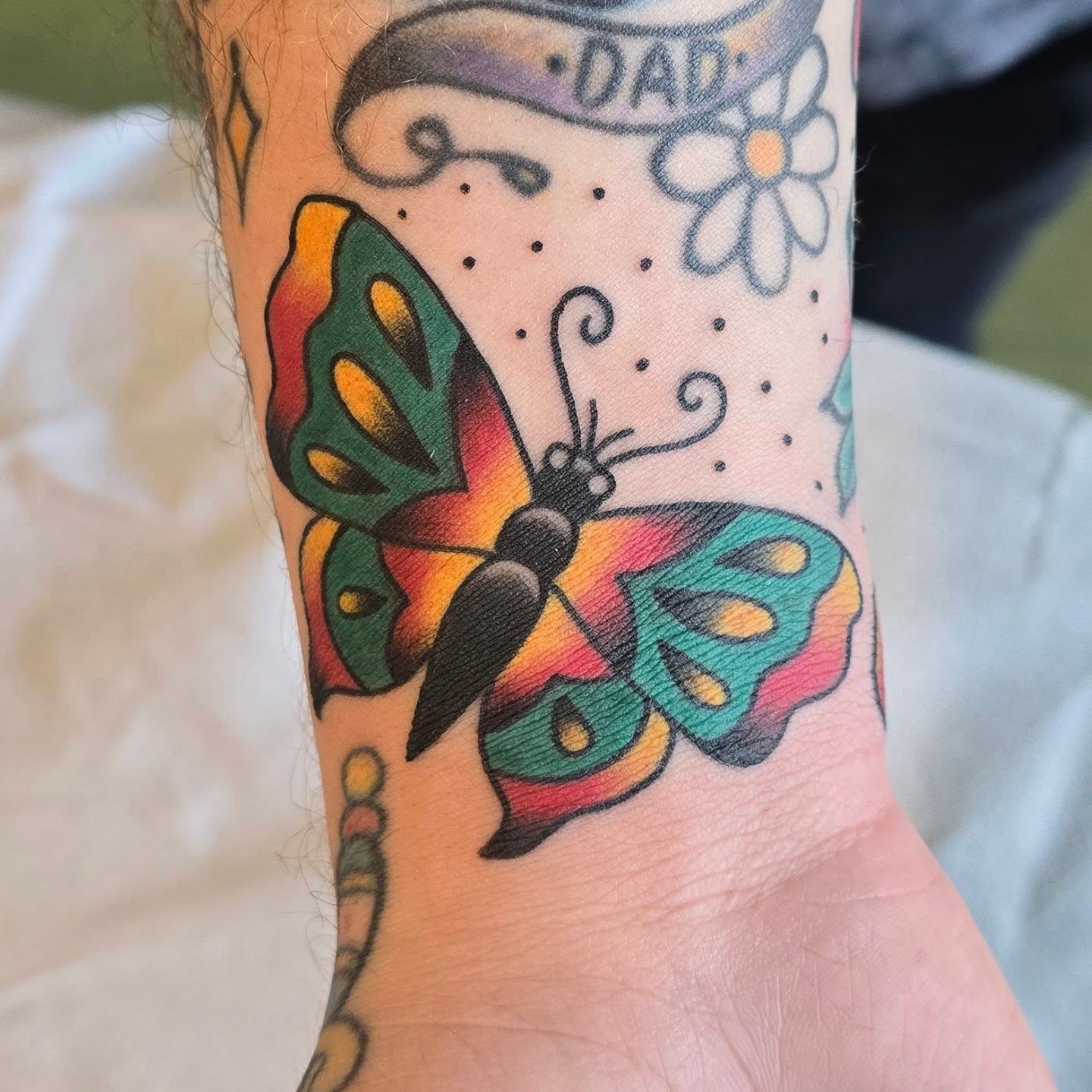 Butterfly American traditional tattoo on the forearm by A. Teixeira, Los Angeles, California
