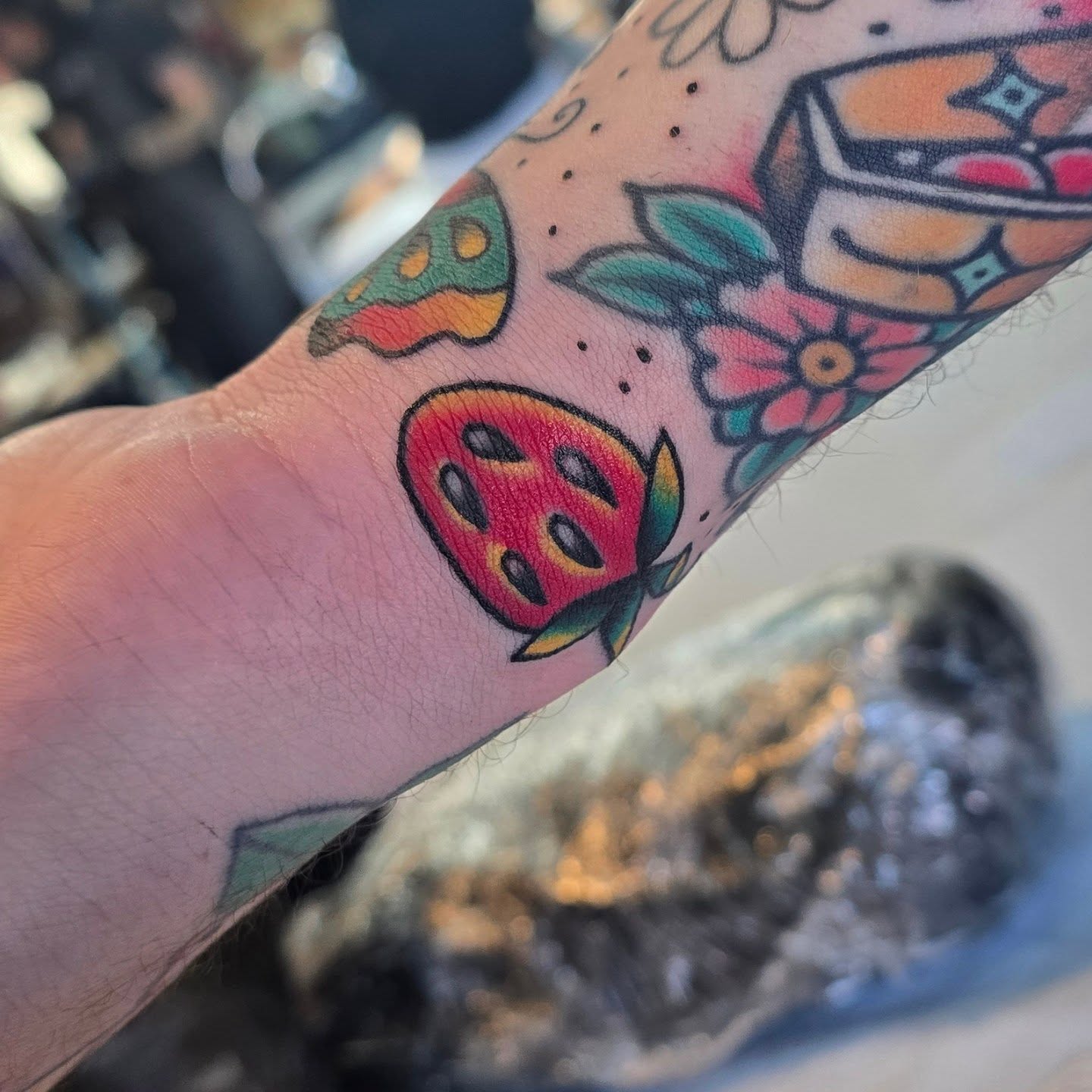 Fruit and floral American traditional tattoo on the forearm by A. Teixeira, Los Angeles, California