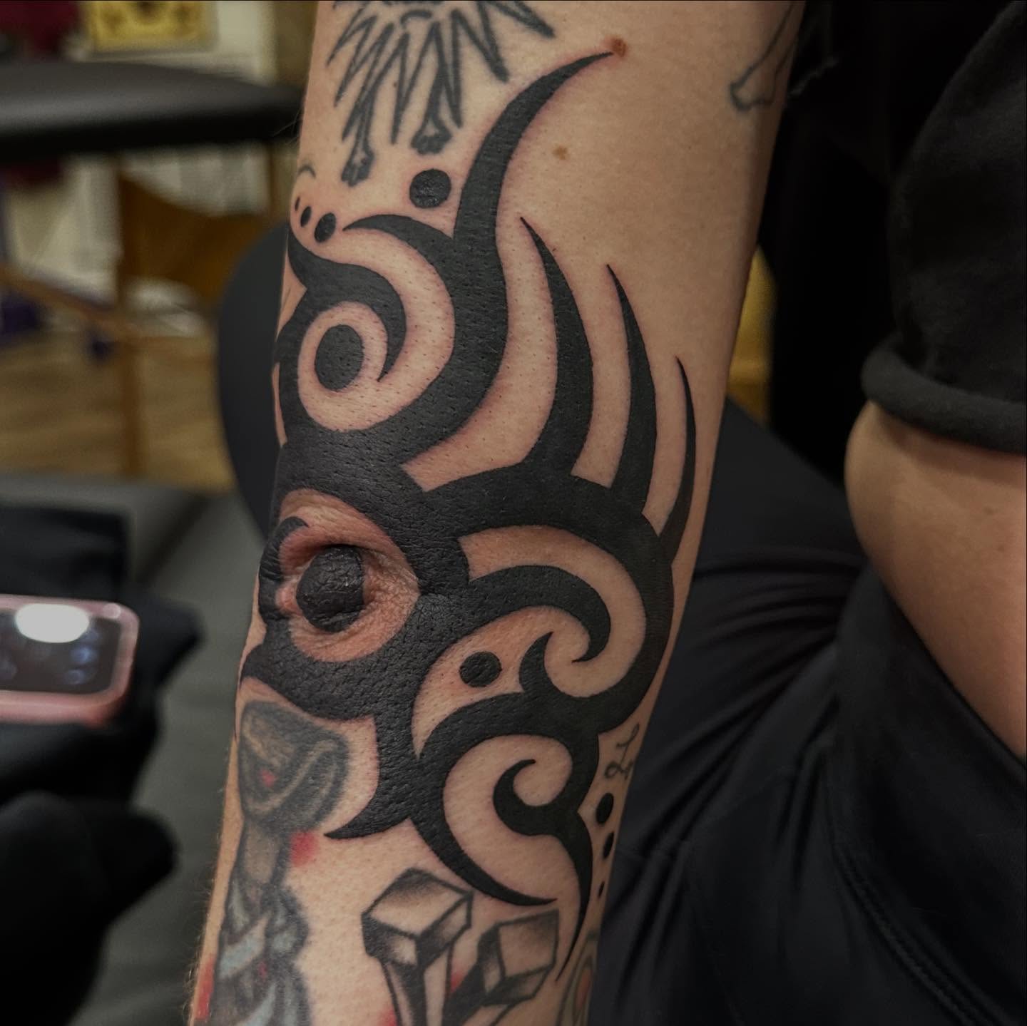 Eye and tribal design tribal tattoo on the forearm by Alexa Wolfkiel