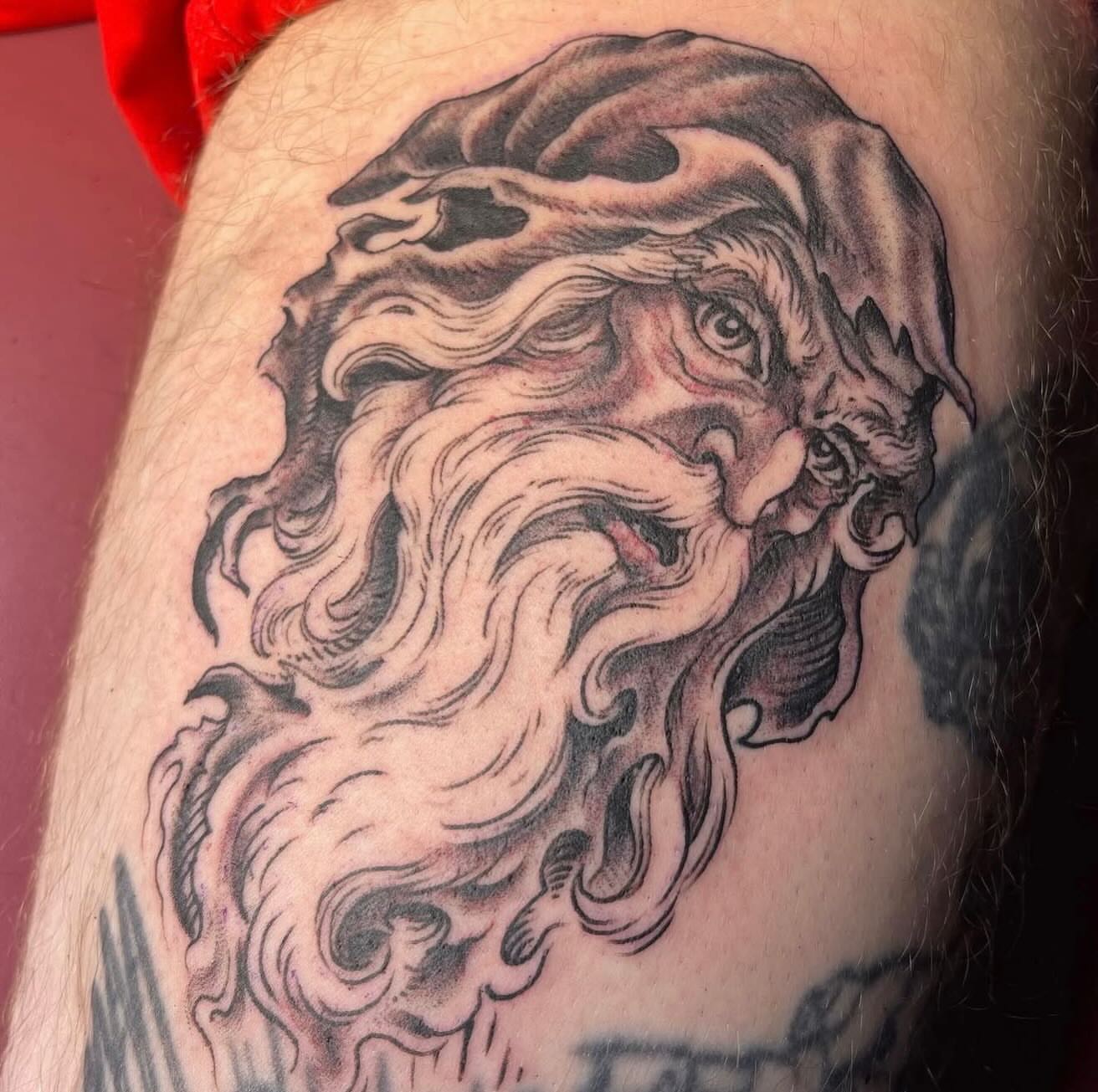 Bearded face black and grey tattoo on the forearm by Mike Wilson