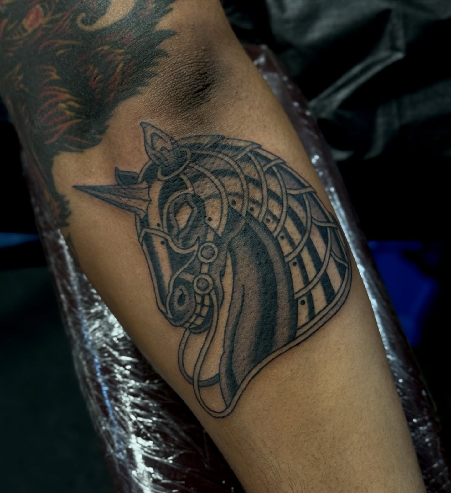 Horse helmet black and grey tattoo on the forearm by Christopher  Cousins, Nashville, Tennessee
