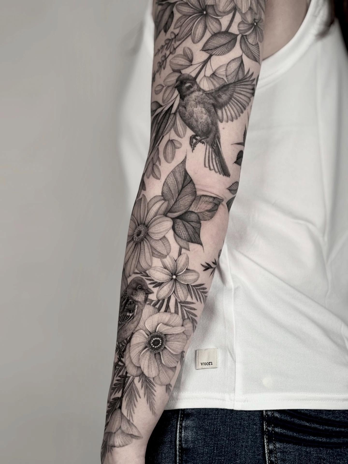 Bird and floral realism tattoo on the forearm by Brittney Naami, San Francisco, California