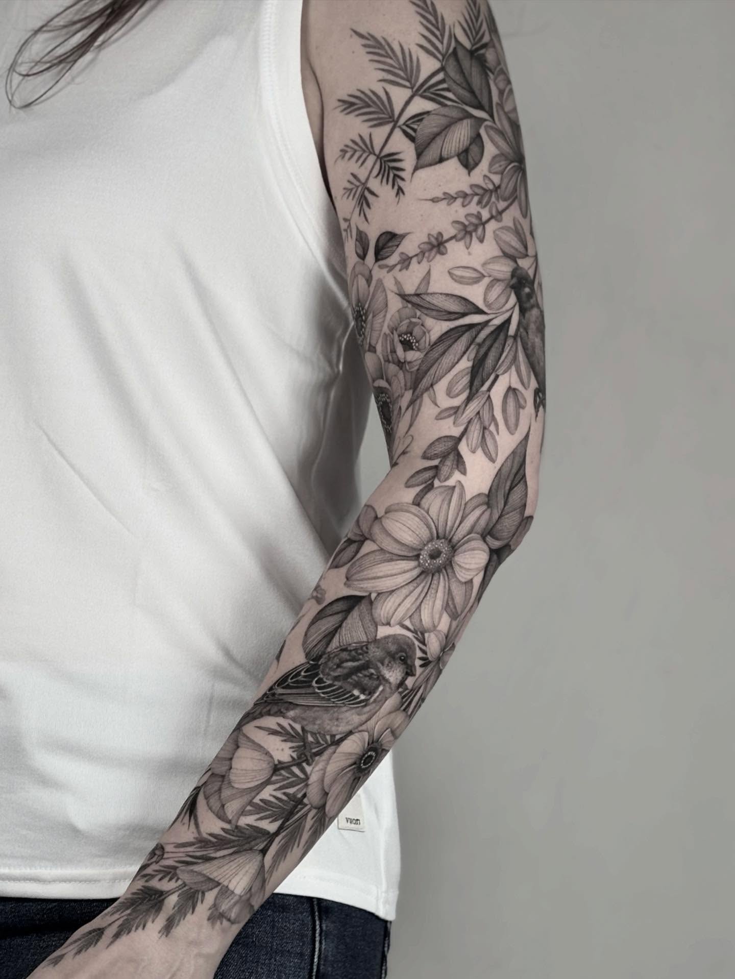 Floral and bird black and grey tattoo on the forearm by Brittney Naami, San Francisco, California