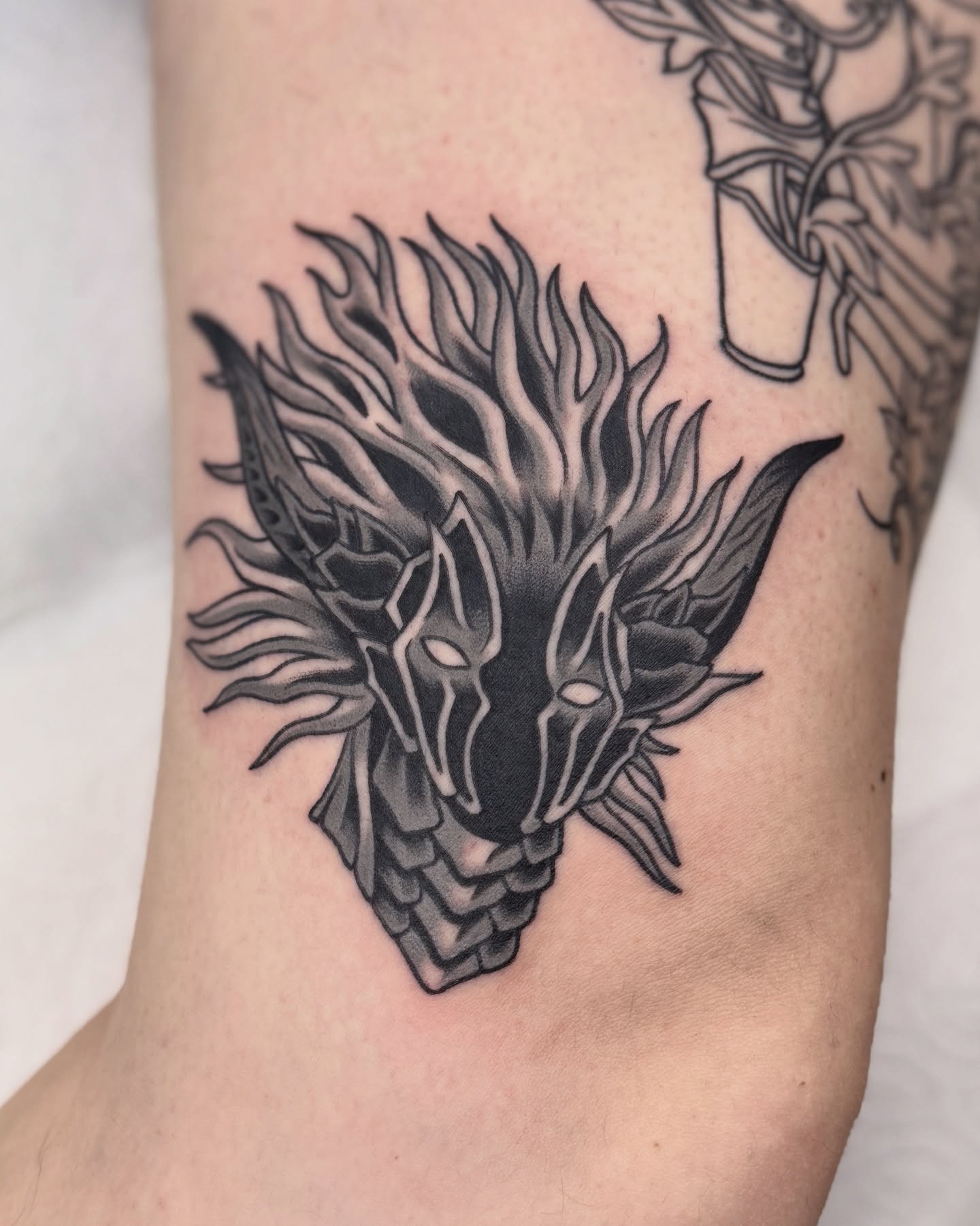 Dragon head geometric tattoo on the forearm by Nia (Knee-uhh) 🦷