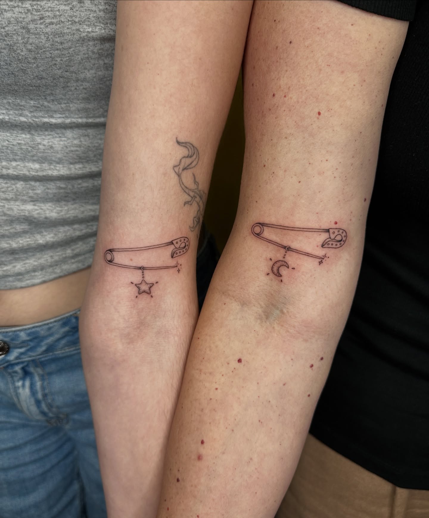 Safety pin black and grey tattoo on the forearm by Fabian💉 Tattoo artist