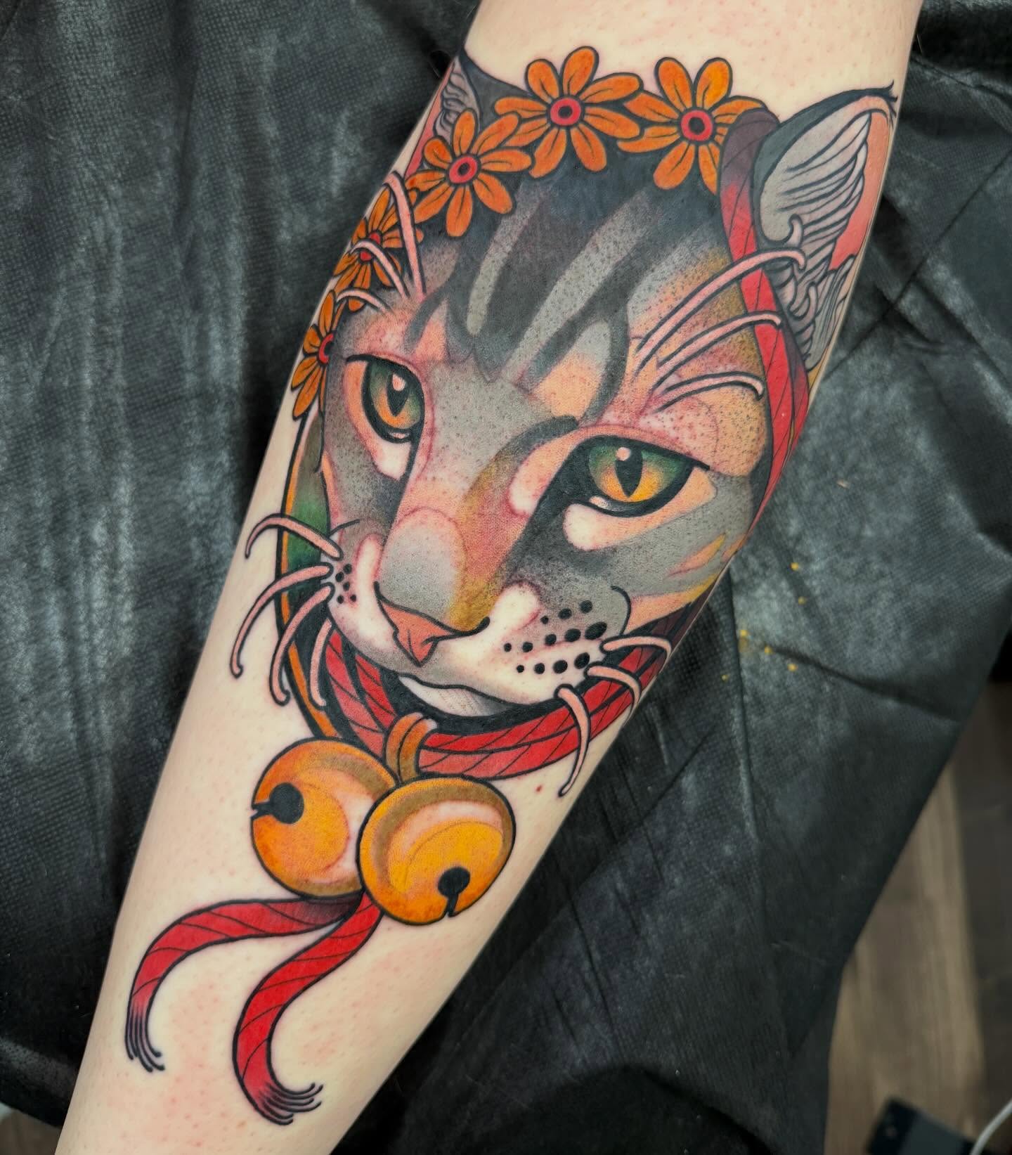 Cat with flowers realism tattoo on the forearm by Spencer Webb