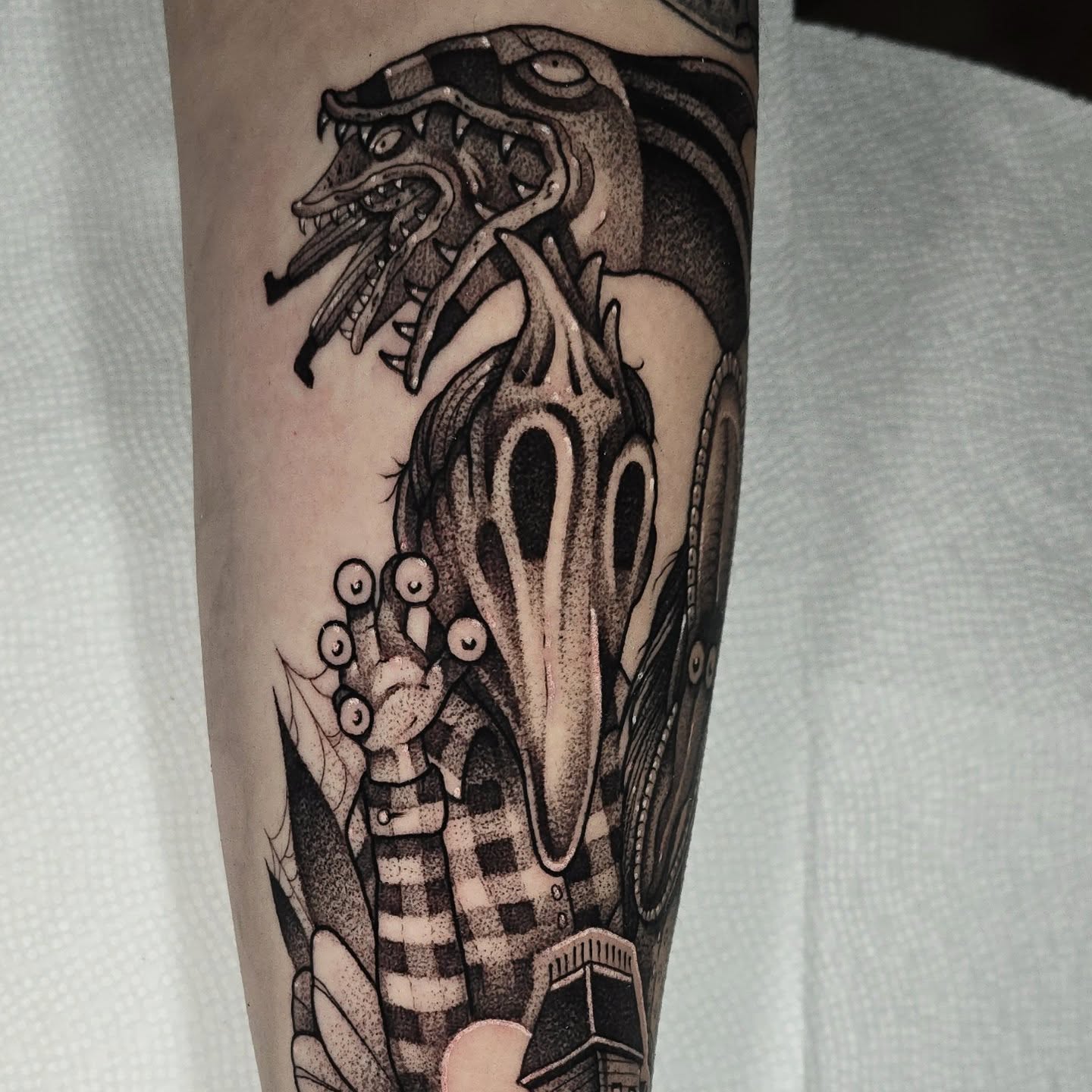 Monster dotwork tattoo on the forearm by Justin Eldridge