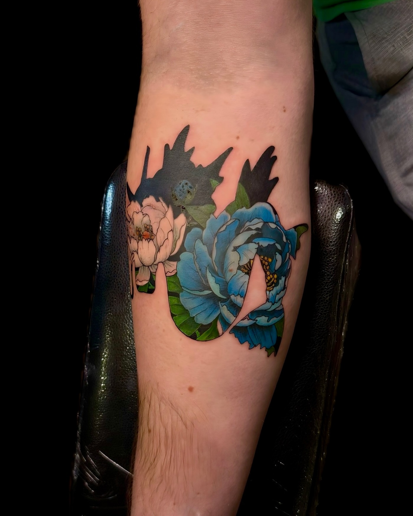 Peony flowers American traditional tattoo on the forearm by Ethan Lund