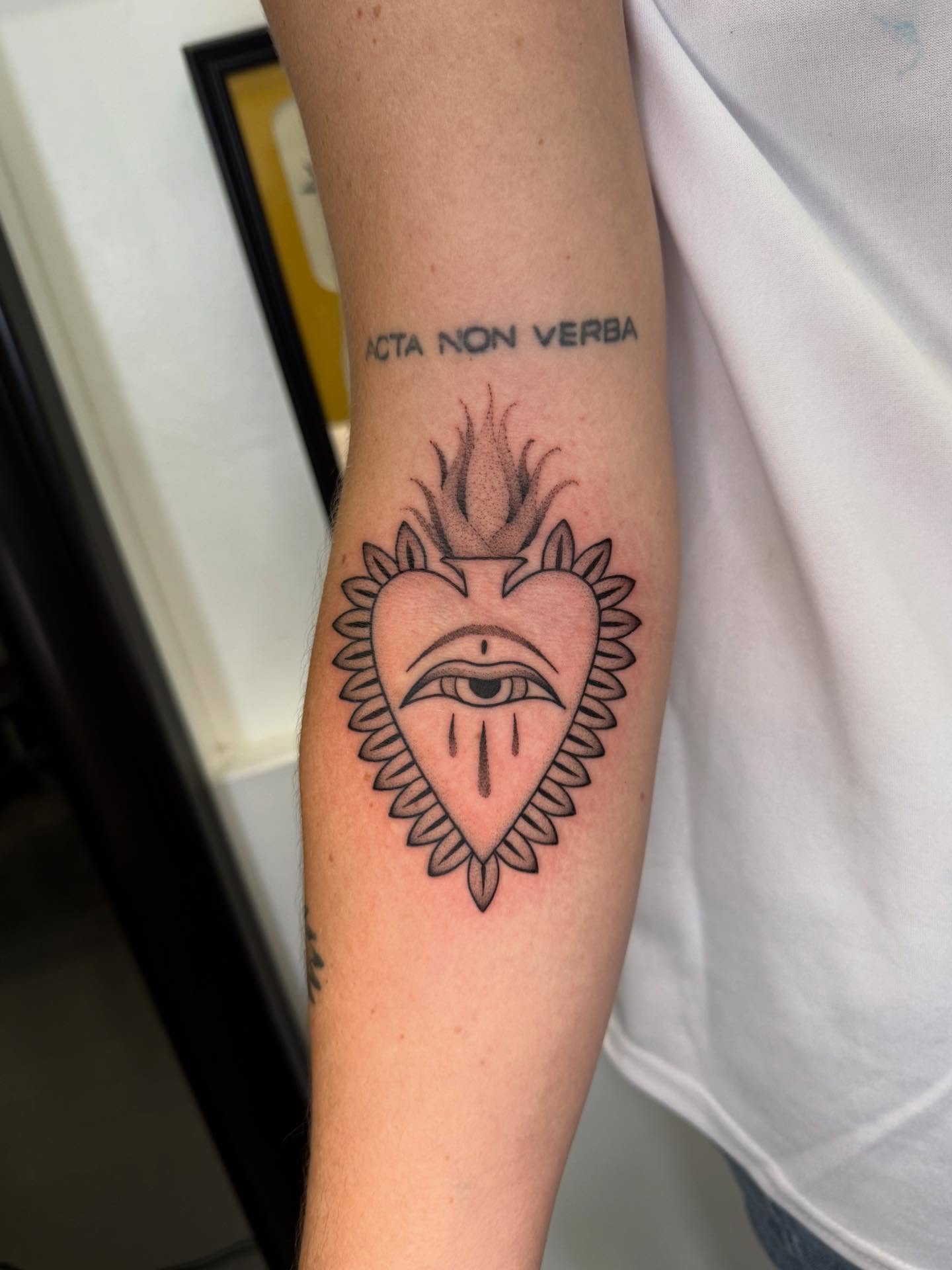 Heart with eye black and grey tattoo on the forearm by Erin Shea