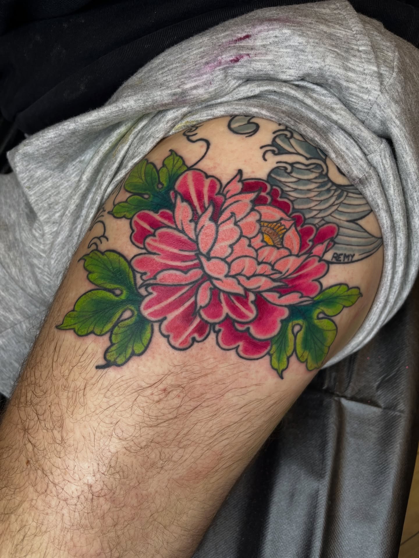 Peony flower American traditional tattoo on the thigh by Winston Thai