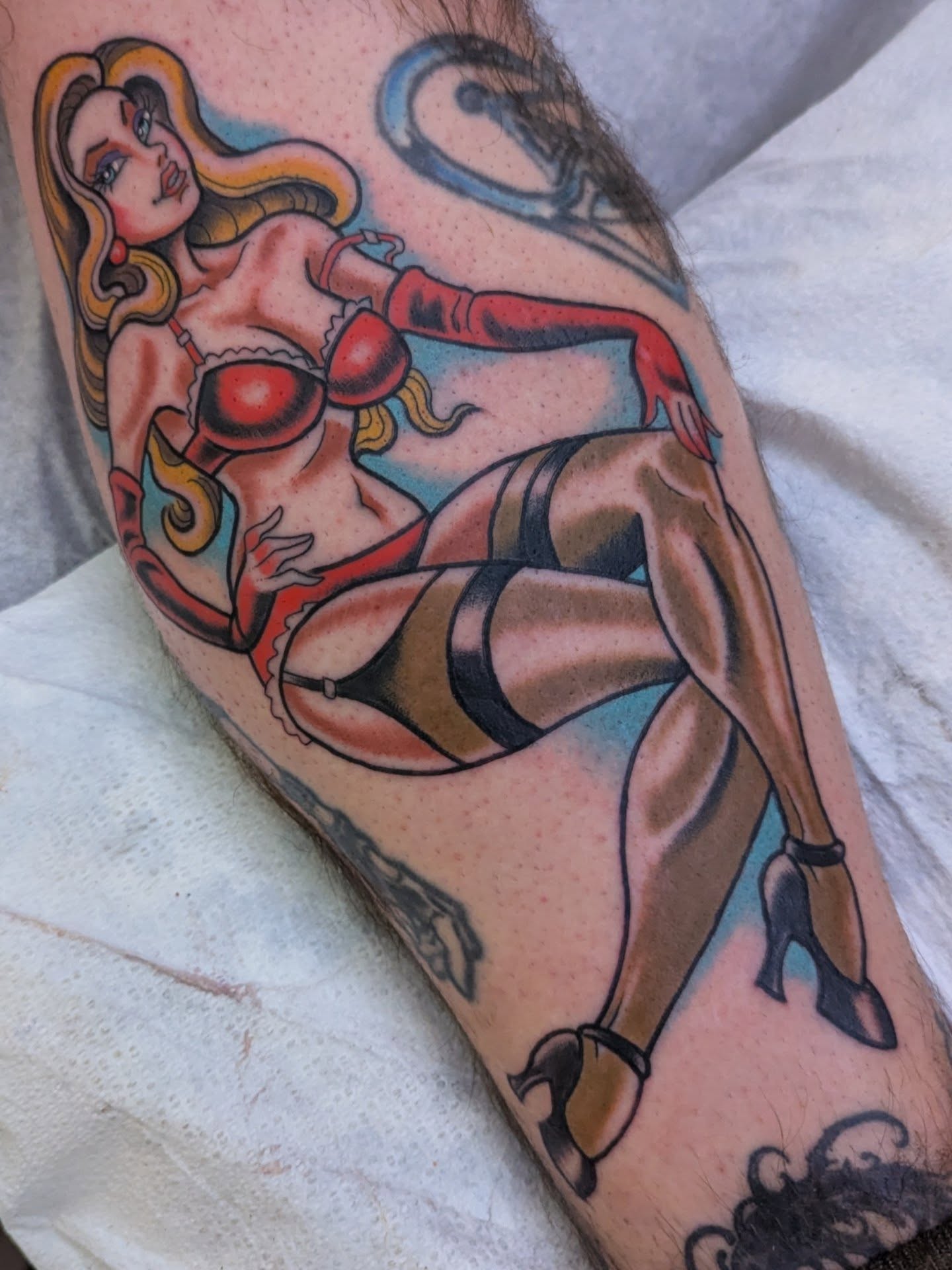 Pin-up girl American traditional tattoo on the forearm by Ryan Slegel
