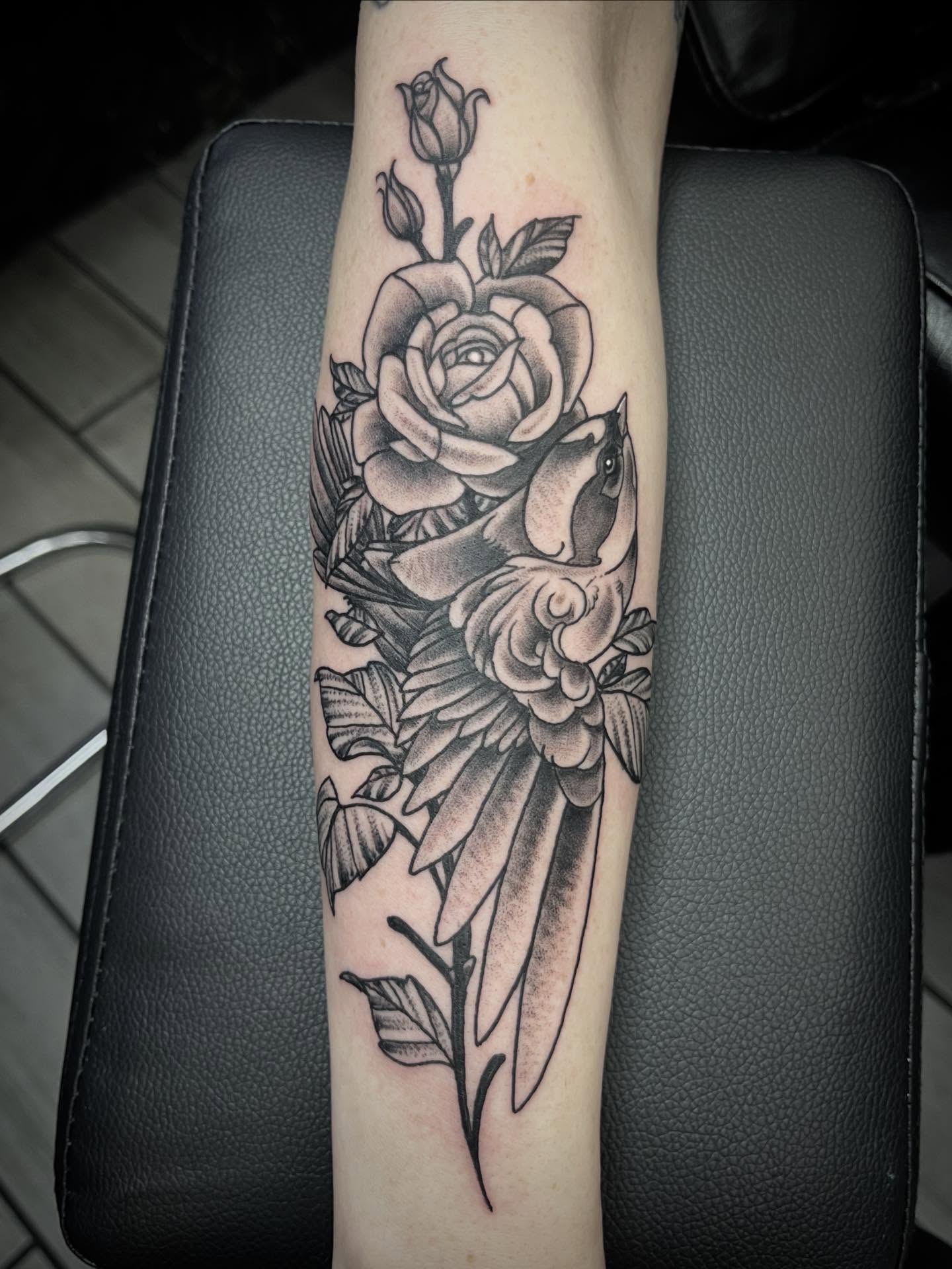 Roses and bird realism tattoo on the forearm by Sean Gallagher