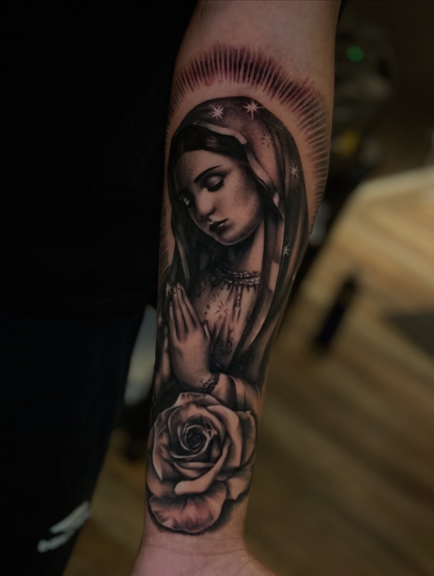 Religious figure with rose realism tattoo on the forearm by ✨tiffy ✨