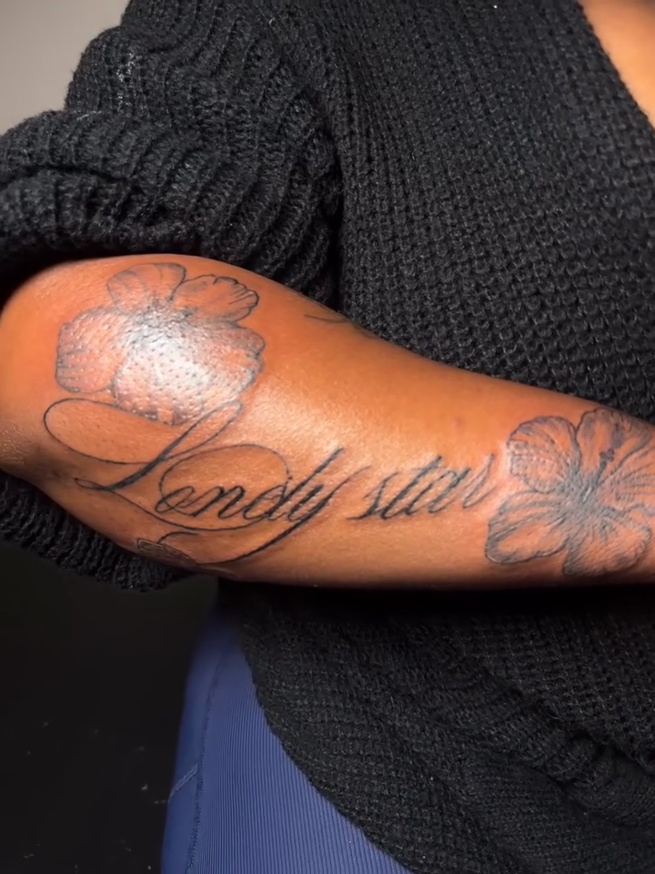Script tattoo with floral elements lettering tattoo on the forearm by Mc X Happo
