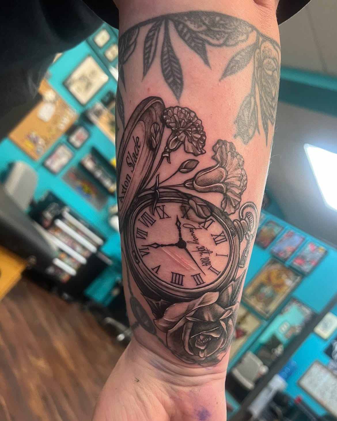 Clock and floral realism tattoo on the forearm by Chelsea Nichole