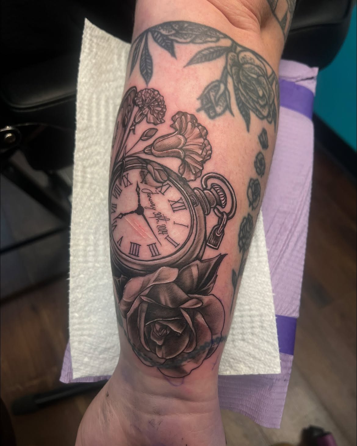 Clock and roses realism tattoo on the forearm by Chelsea Nichole