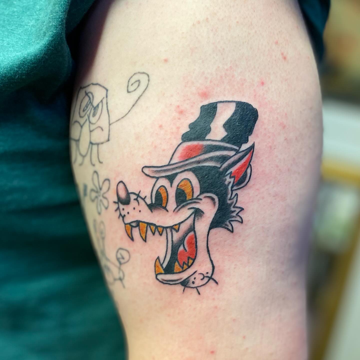 Cat with top hat American traditional tattoo on the upper arm by Tommy O'Connell