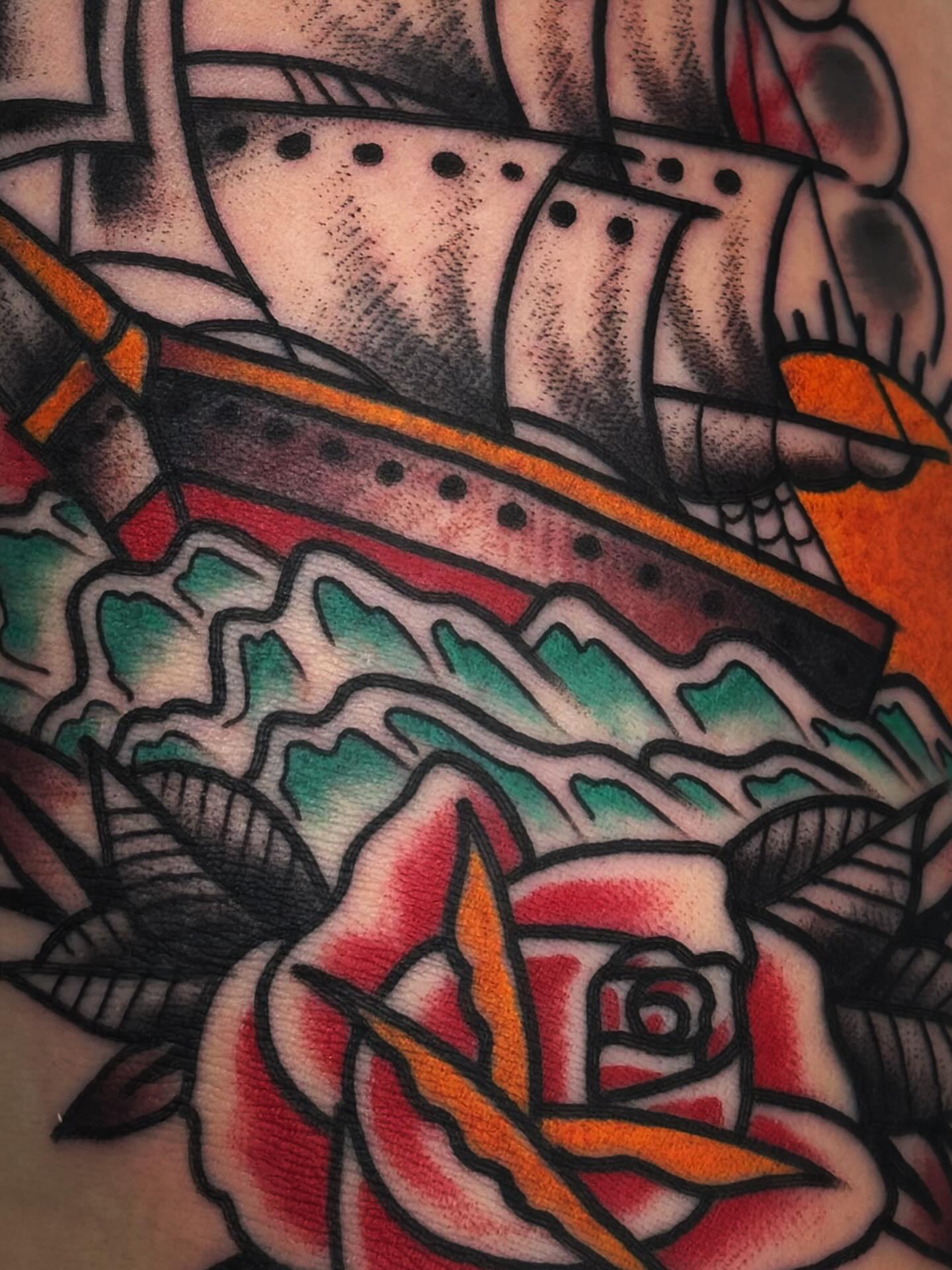 Ship and rose American traditional tattoo on the forearm by Mikey Sarratt